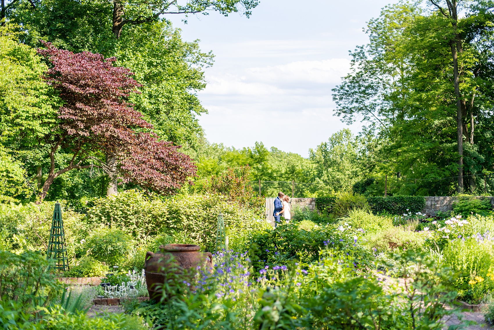 A summer wedding at Olde Mill Inn, NJ. Photos by Mikkel Paige Photography for an event with pink and blue details. The bride and groom chose to have their photos taken at Cross Estate Gardens, just down the road from this New Jersey Venue. Click through for their complete wedding recap! #OldeMillInn #NJwedding #NJweddingphotographer #mikkelpaige #NewJerseyWeddingVenue #NewJerseyWedding #CrossEstateGardens #brideandgroom 