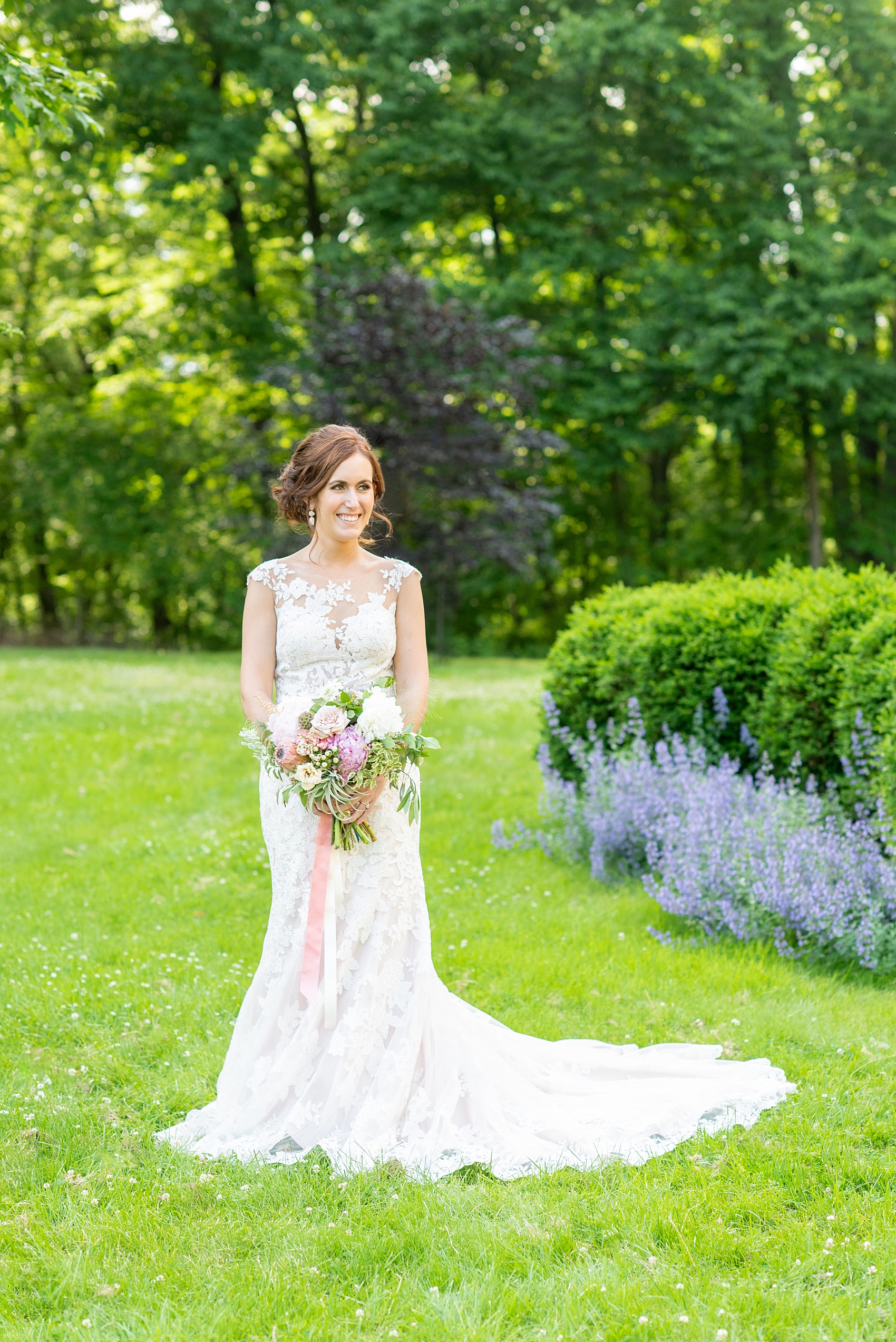 A summer wedding at Olde Mill Inn, NJ. Photos by Mikkel Paige Photography for an event with pink and blue details. The bridal portraits were taken at Cross Estate Gardens, just down the road from this New Jersey Venue. The beautiful pictures of the bride show her lace Allure Bridal gown with appliqué and button detail. Click through for their complete wedding recap! #OldeMillInn #NJwedding #NJweddingphotographer #mikkelpaige #NewJerseyWeddingVenue #NewJerseyWedding #CrossEstateGardens #bridalportraits #bride #herecomesthebride #AllureBridal #laceweddinggown