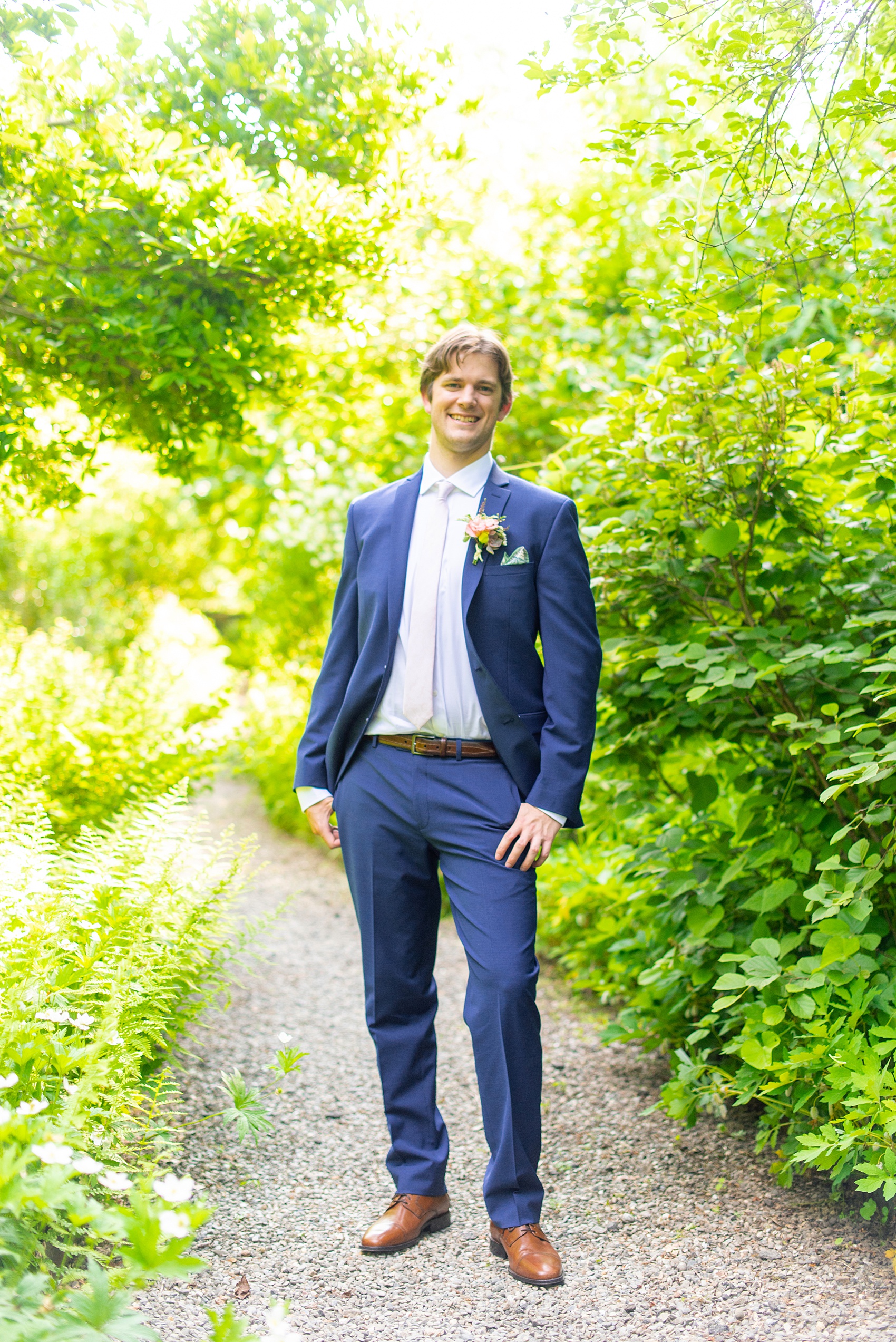 A summer wedding at Olde Mill Inn, NJ. Photos by Mikkel Paige Photography for an event with light pink and blue details. The groom wore a blue suit for his New Jersey venue event. A NYC pattern pocket square, highlighting Jersey City where the bride and groom live, finished the look with a white satin tie. Click through for their complete wedding recap! #OldeMillInn #NJwedding #NJweddingphotographer #mikkelpaige #NewJerseyWeddingVenue #NewJerseyWedding #CrossEstateGardens #groom #groomsuits #bluesuit #groomdetails