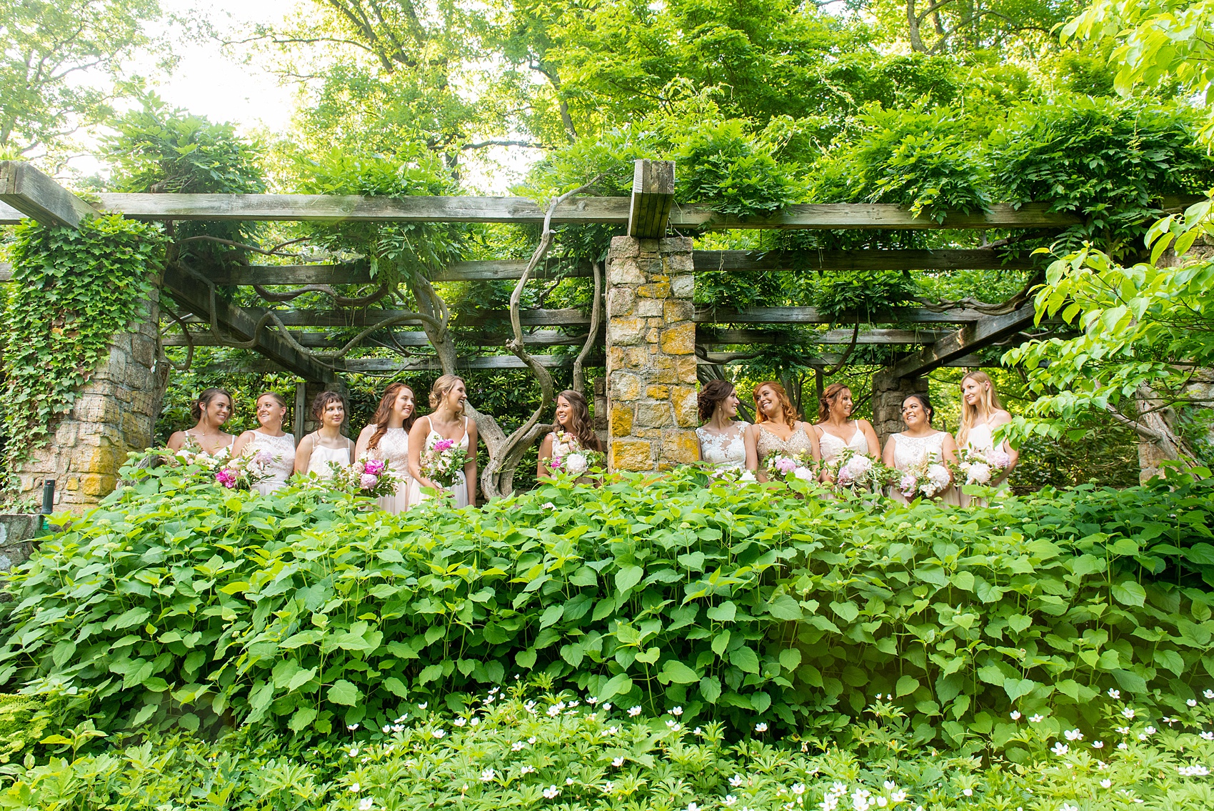 A summer wedding at Olde Mill Inn, NJ. Photos by Mikkel Paige Photography. This New Jersey venue is a great option for an event not too far from NYC. The wedding party photos were at nearby Cross Estate Gardens, a beautiful lush area for bridal party photos. The bridesmaids wore light pink, mis-matched gowns. Click through for their complete wedding recap! #OldeMillInn #NJwedding #NJweddingphotographer #mikkelpaige #NewJerseyWeddingVenue #NewJerseyWedding #CrossEstateGardens #weddingdetails #bridalparty #pinkbridesmaids #mismatcheddresses #mismatchedbridesmaids