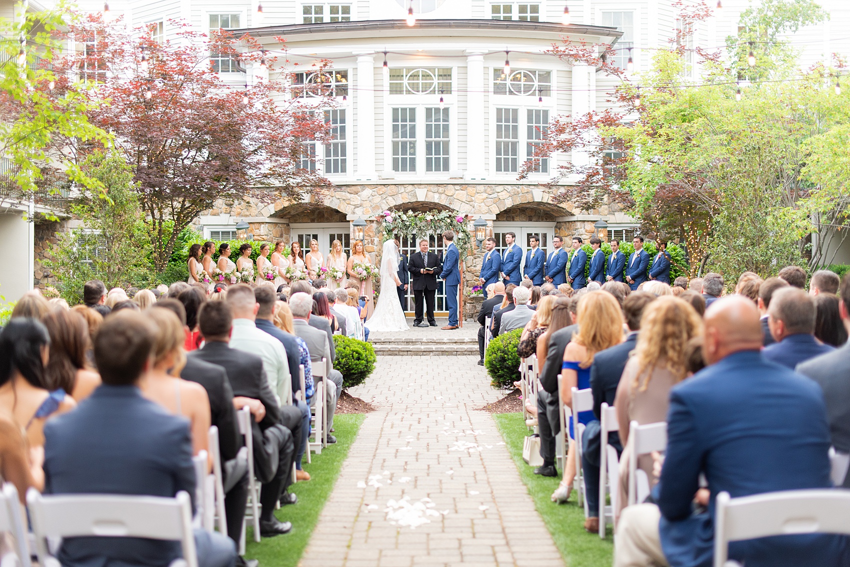 A summer wedding at Olde Mill Inn, NJ. Photos by Mikkel Paige Photography for an event with light pink and blue details. This New Jersey venue is a great option for something not too far from NYC. The couple had their ceremony in the interior courtyard. Click through for their complete wedding recap! #OldeMillInn #NJwedding #NJweddingphotographer #mikkelpaige #NewJerseyWeddingVenue #NewJerseyWedding #CrossEstateGardens 