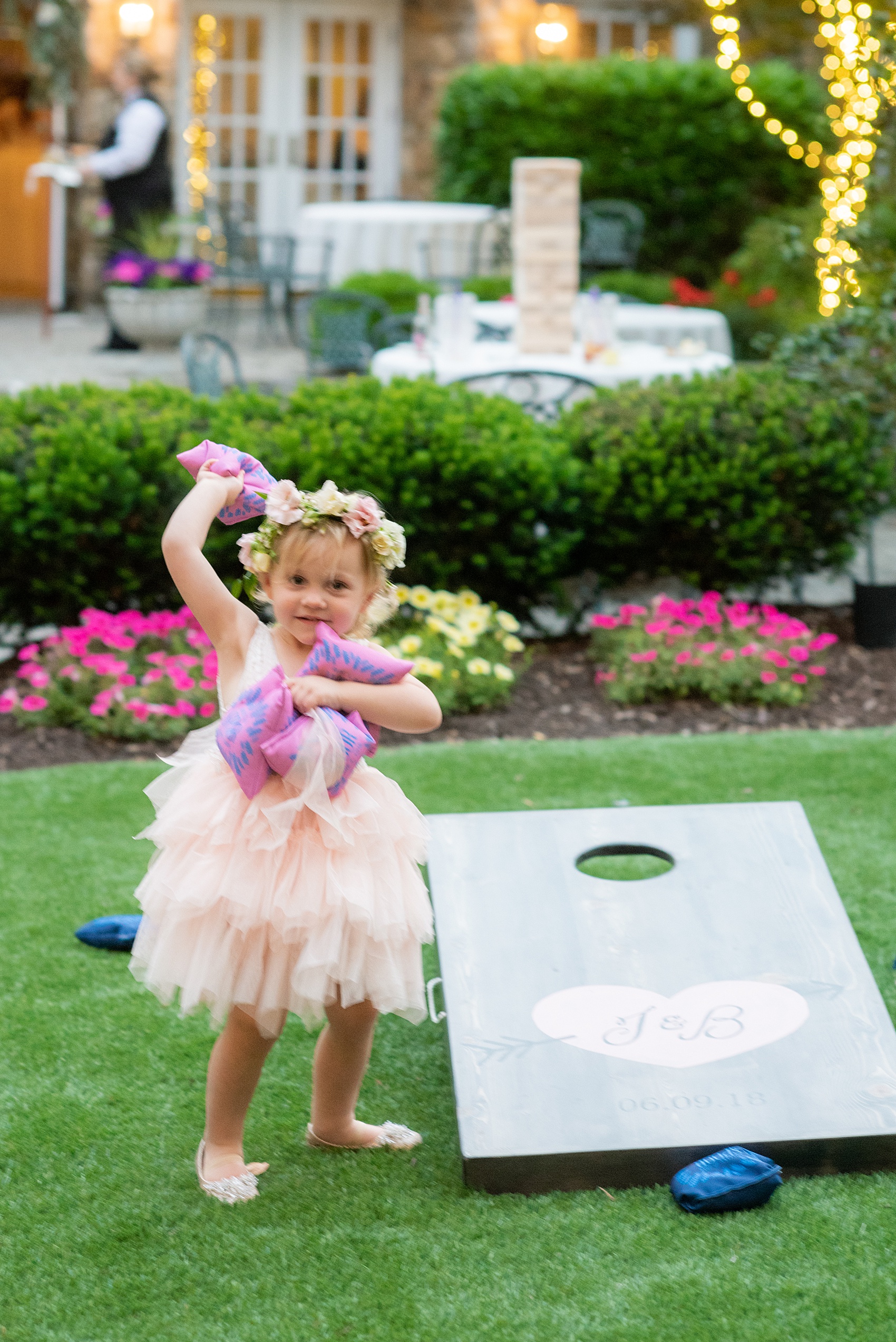 A June wedding at Olde Mill Inn, NJ. Photos by Mikkel Paige Photography for an event with pink details. This New Jersey venue is a great option for something not too far from NYC. Their custom corn hole boards matched their wedding logo and signature heart! Even the flower girl enjoyed playing during cocktail hour! Click through for their complete wedding recap! #OldeMillInn #NJwedding #NJweddingphotographer #mikkelpaige #NewJerseyWeddingVenue #NewJerseyWedding #cornhole #customweddingdetails #weddinglogo #uniqueweddingdetails #MidsummerNightsDream