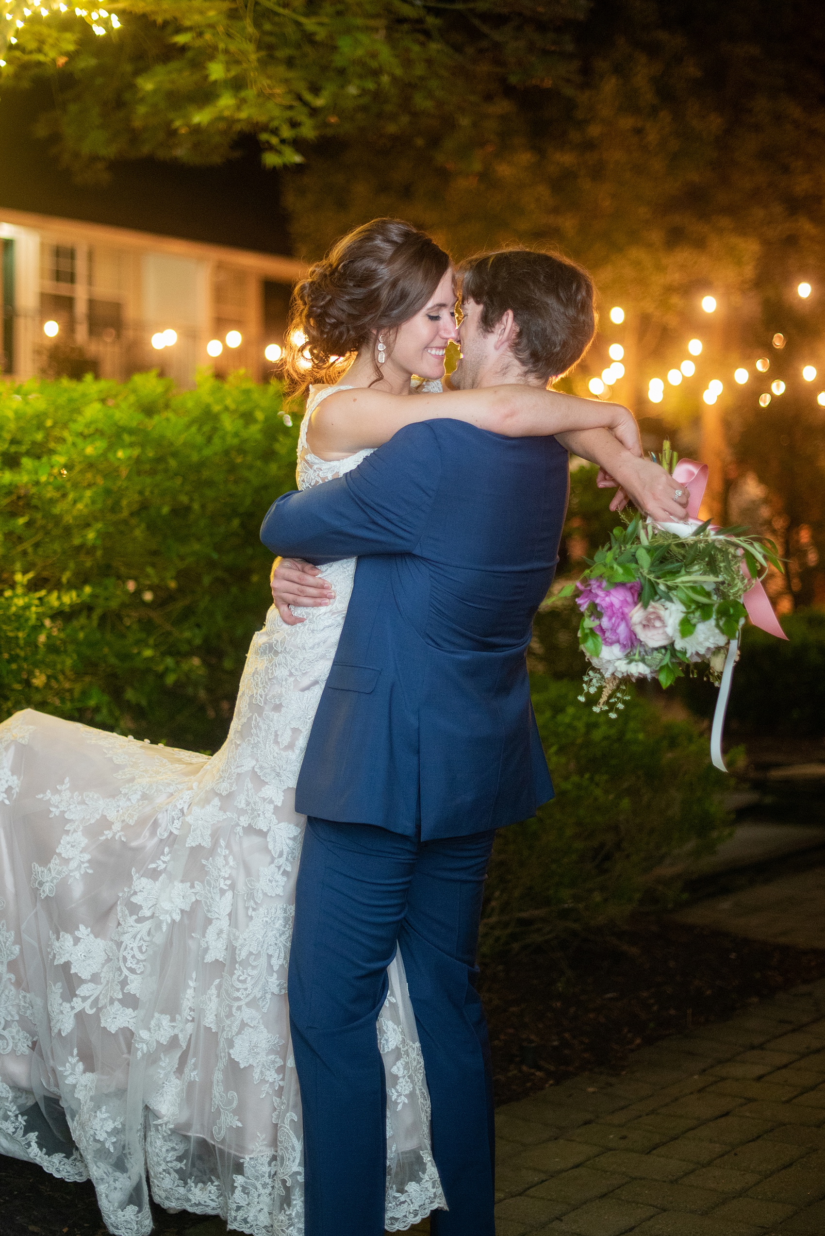 A June wedding at Olde Mill Inn, NJ. Photos by Mikkel Paige Photography for an event with pink details. This New Jersey venue is a great option for something not too far from NYC. The reception was filled with unique glass terrarium vases, colorful pink flowers and greenery, peonies and Midsummer Night’s Dream theme details. The bride and groom hugged outside towards the end of their reception, under the hanging bistro lights. Click through for their complete wedding recap! #OldeMillInn #NJwedding #NJweddingphotographer #mikkelpaige #NewJerseyWeddingVenue #NewJerseyWedding #lastkiss #MidsummerNightsDream