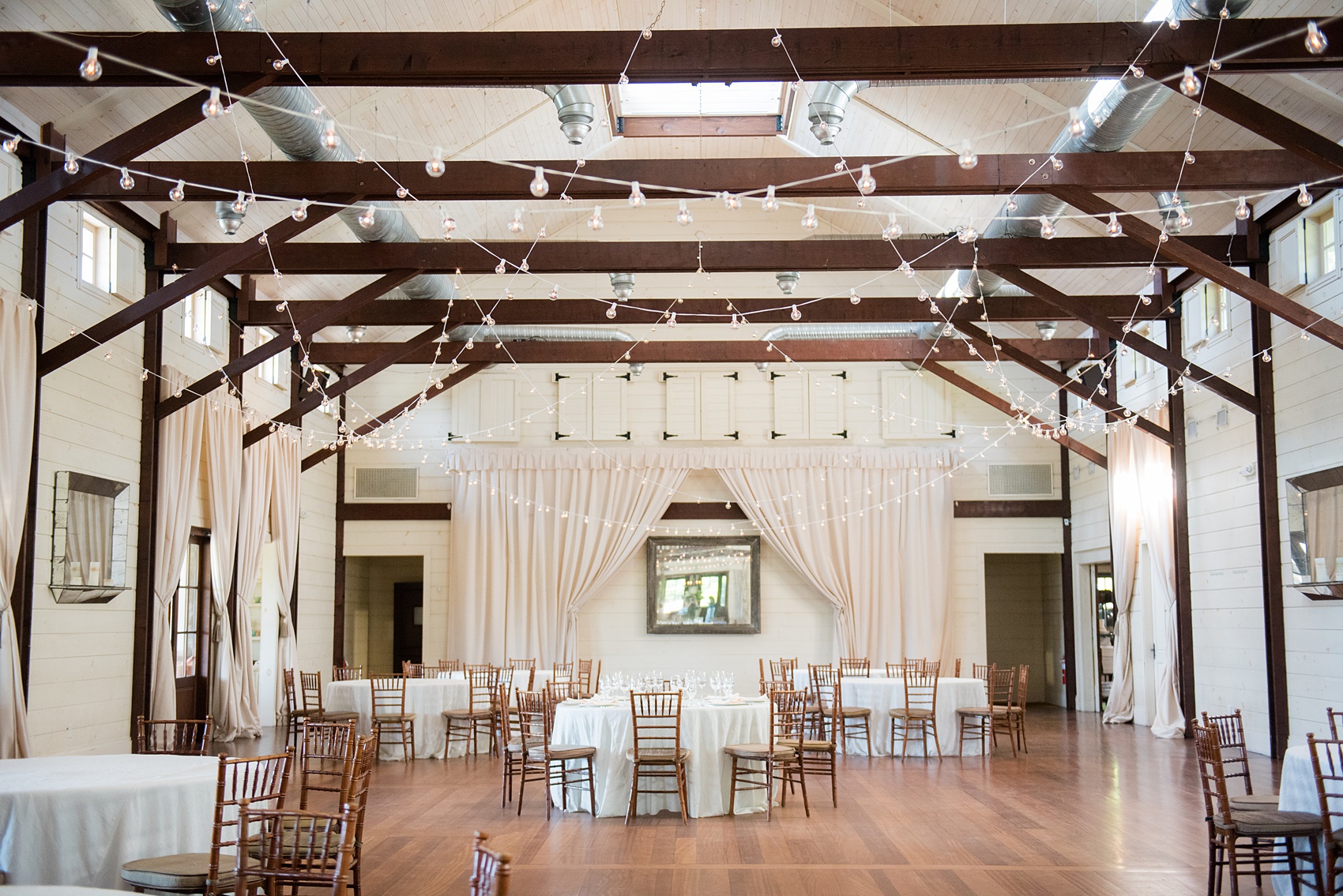 Pippin Hill wedding photos by Mikkel Paige Photography in Charlottesville, Virginia. This chic venue is on a vineyard and has beautiful views of the Blue Ridge Mountains. The white washed reception area is beautiful with string lights. Click through for more images from this venue! #VirginiaWeddingVenues #PippinHill #VineyardWedding #CharlottesvilleVA #RatherbeinCville