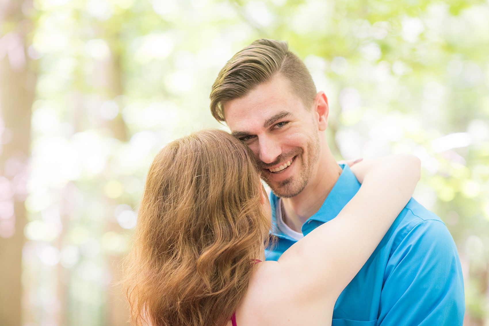 Maryland summer engagement photos by Mikkel Paige Photography. This couple wore semi-formal outfits with the bride in a beautiful, sexy back fuchsia pink gown and the groom in a blue button down and grey pants. Their elegant outdoor park pictures were perfect for the season! Click through to see more from their romantic pictures in the woods! #mikkelpaige #summerengagementphotos #marylandengagementphotos #marylandweddingphotographer #parkengagementsession #engagementphotooutfitideas #engagementphotos #savethedatephotos 