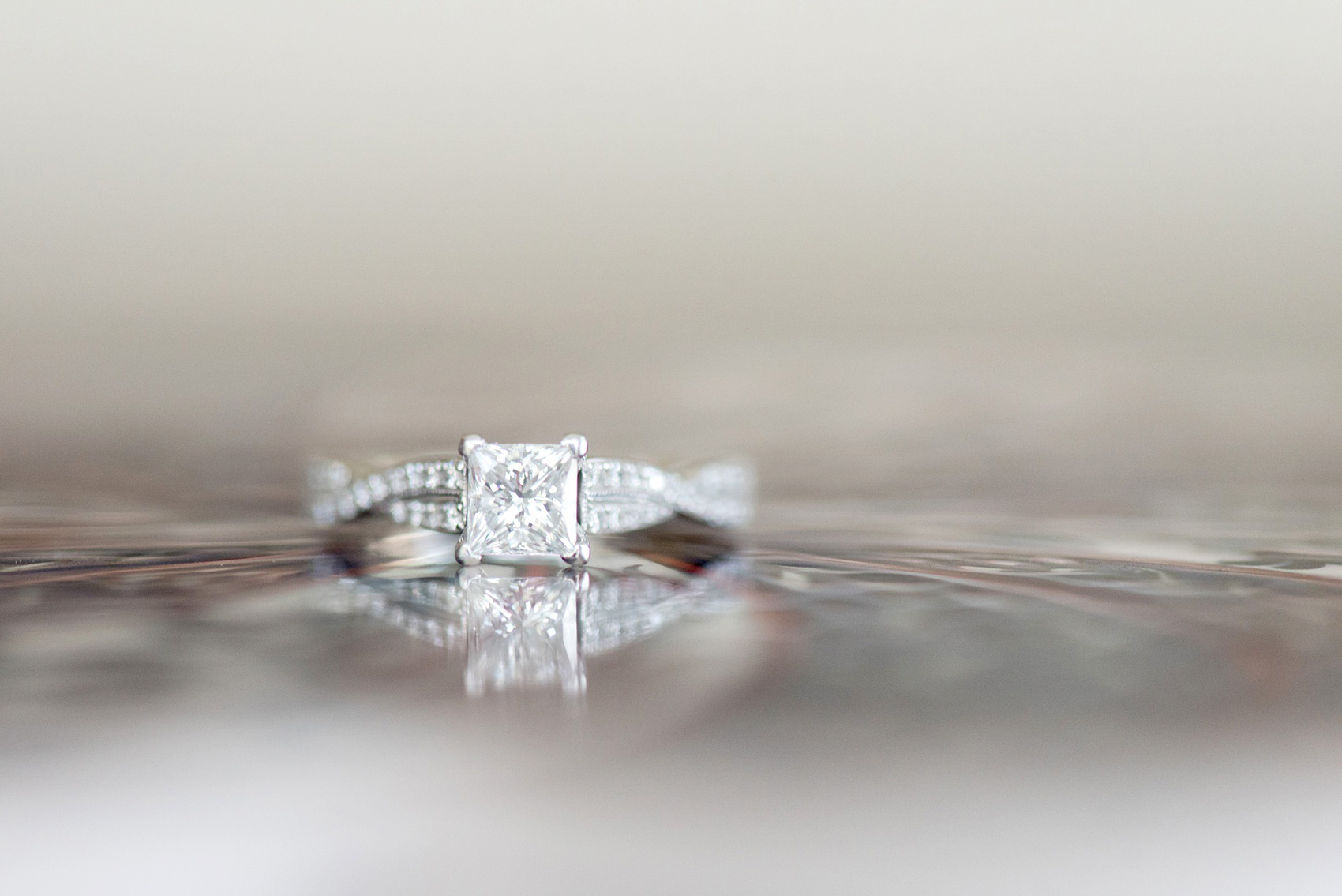 Maryland summer engagement photos by Mikkel Paige Photography. This couple wore semi-formal outfits with the bride in a beautiful, sexy back fuchsia pink gown and the groom in a blue button down and grey pants. Their elegant outdoor park pictures were perfect for the season! This detail photo shows the bride's unique square cut diamond ring. Click through to see more from their romantic pictures in the woods! #mikkelpaige #summerengagementphotos #marylandengagementphotos #marylandweddingphotographer #parkengagementsession #engagementphotooutfitideas #engagementphotos #savethedatephotos 