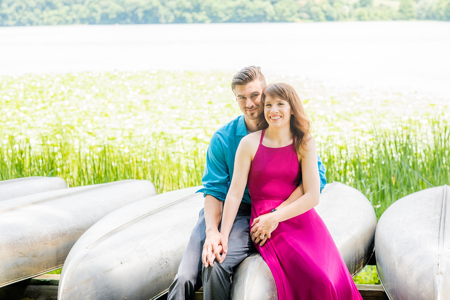 Maryland summer engagement photos by Mikkel Paige Photography. This couple wore semi-formal outfits with the bride in a beautiful, sexy back fuchsia pink gown and the groom in a blue button down and grey pants. Their elegant outdoor park pictures were perfect for the season! Click through to see more from their romantic pictures in the woods! #mikkelpaige #summerengagementphotos #marylandengagementphotos #marylandweddingphotographer #parkengagementsession #engagementphotooutfitideas #engagementphotos #savethedatephotos 