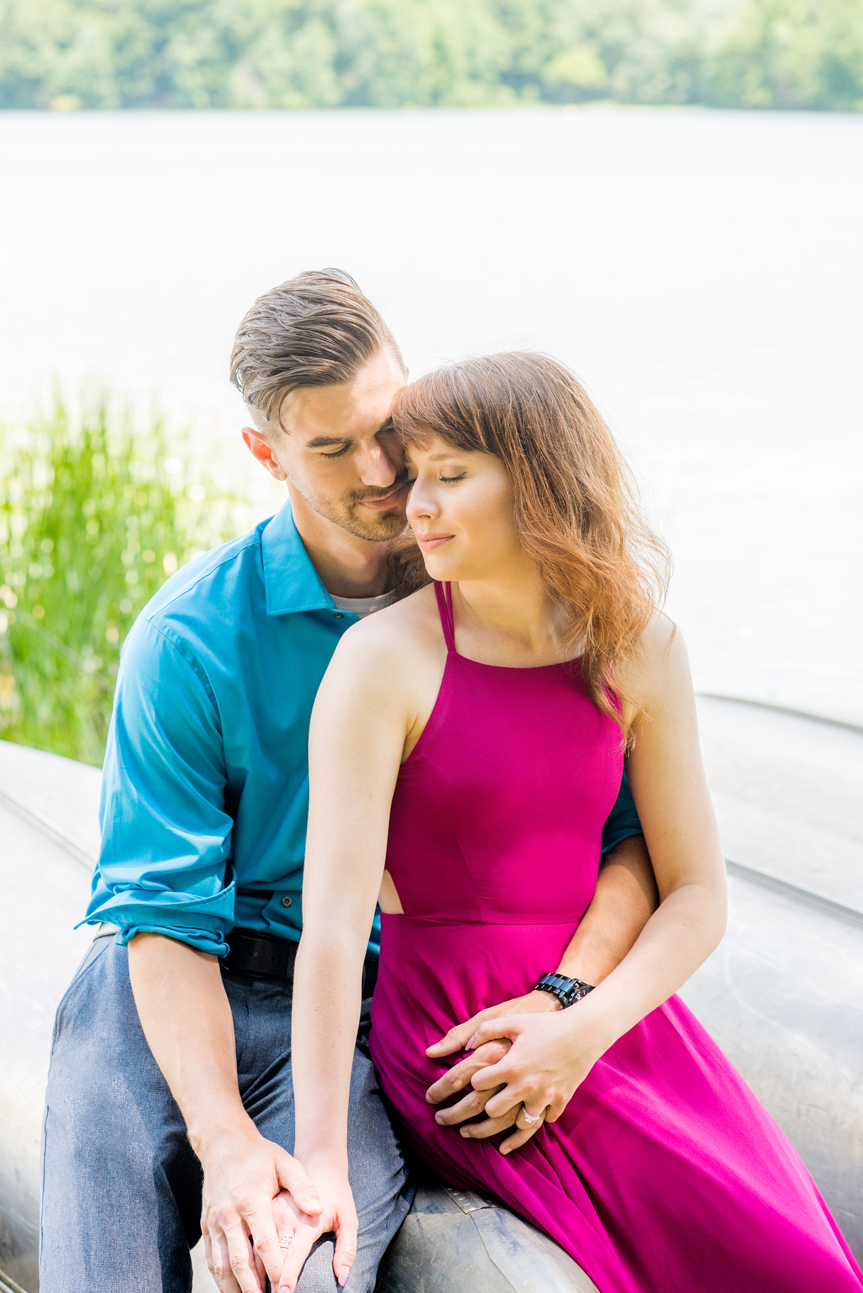 Maryland summer engagement photos by Mikkel Paige Photography. This couple wore semi-formal outfits with the bride in a beautiful, sexy back fuchsia pink gown and the groom in a blue button down and grey pants. Their elegant outdoor park pictures were perfect for the season! Click through to see more from their romantic pictures in the woods! #mikkelpaige #summerengagementphotos #marylandengagementphotos #marylandweddingphotographer #parkengagementsession #engagementphotooutfitideas #engagementphotos #savethedatephotos 