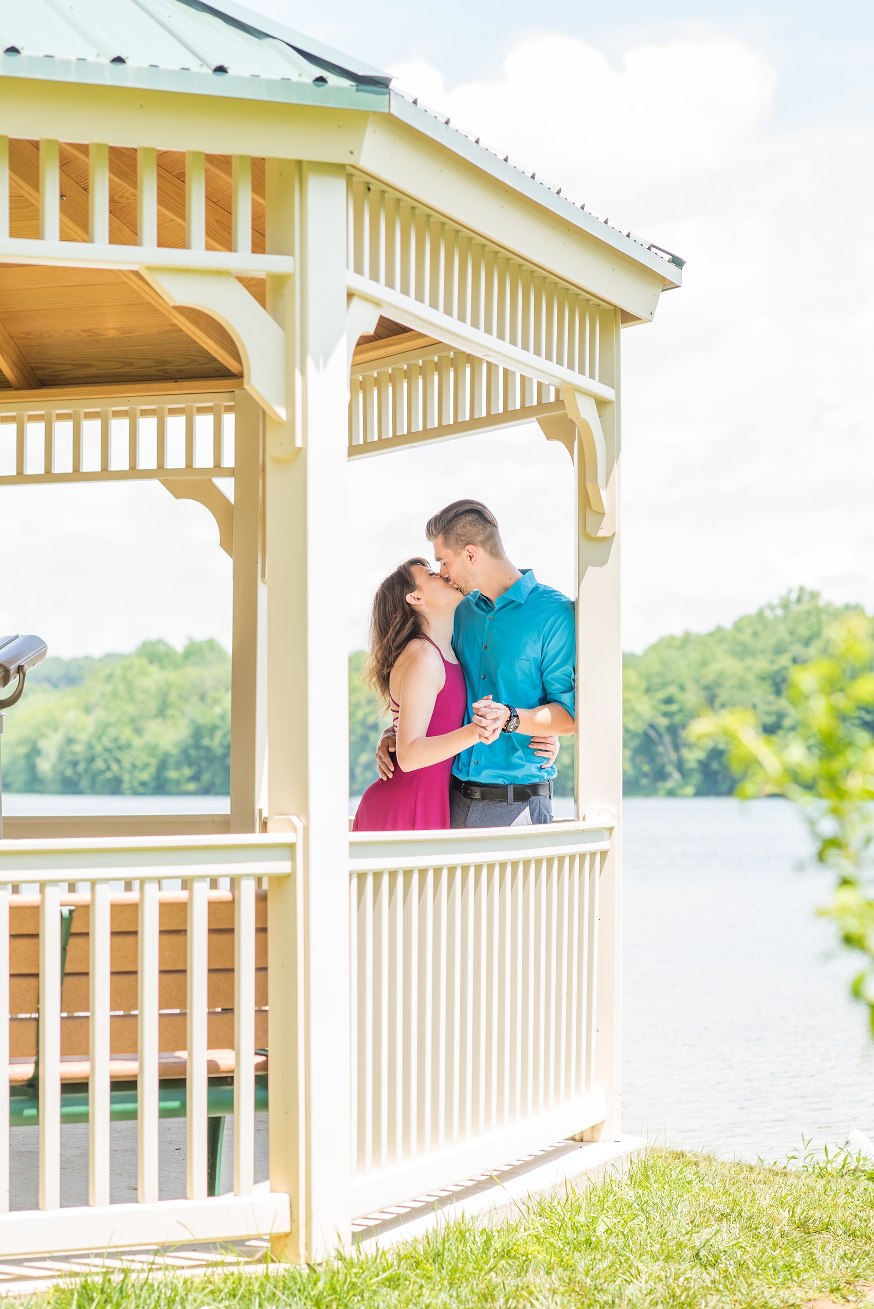 Maryland summer engagement photos by Mikkel Paige Photography. This couple wore semi-formal outfits with the bride in a beautiful, sexy back fuchsia pink gown and the groom in a blue button down and grey pants. Their elegant outdoor park pictures were perfect for the season! Click through to see more from their romantic pictures in the woods! #mikkelpaige #summerengagementphotos #marylandengagementphotos #marylandweddingphotographer #parkengagementsession #engagementphotooutfitideas #engagementphotos #savethedatephotos 