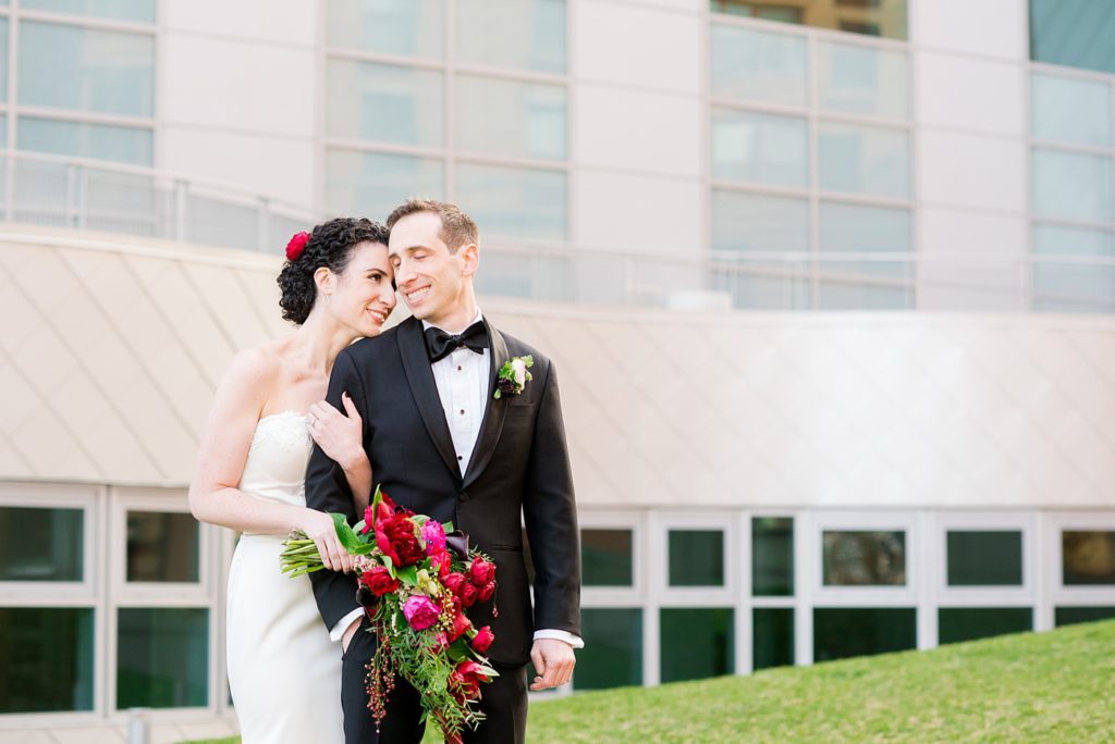 W Hoboken wedding photos in New Jersey by Mikkel Paige Photography. Black tuxedos and dresses were accented by colorful flowers and the NYC skyline for an April wedding.