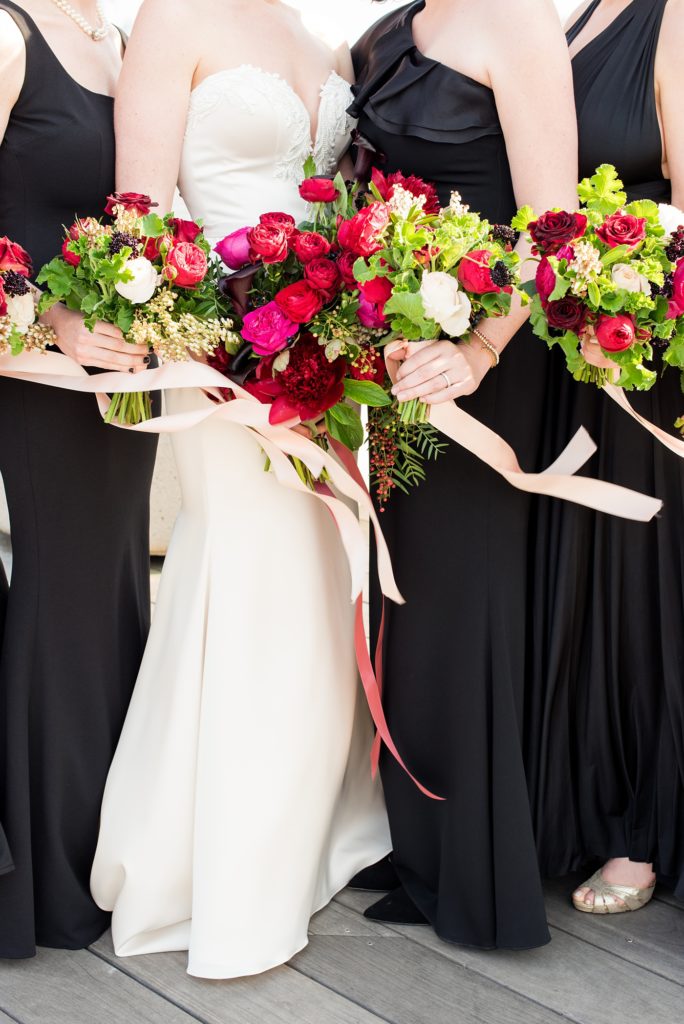 W Hoboken wedding photos in New Jersey by Mikkel Paige Photography. Black tuxedos and dresses were accented by colorful flowers and the NYC skyline for an April wedding.