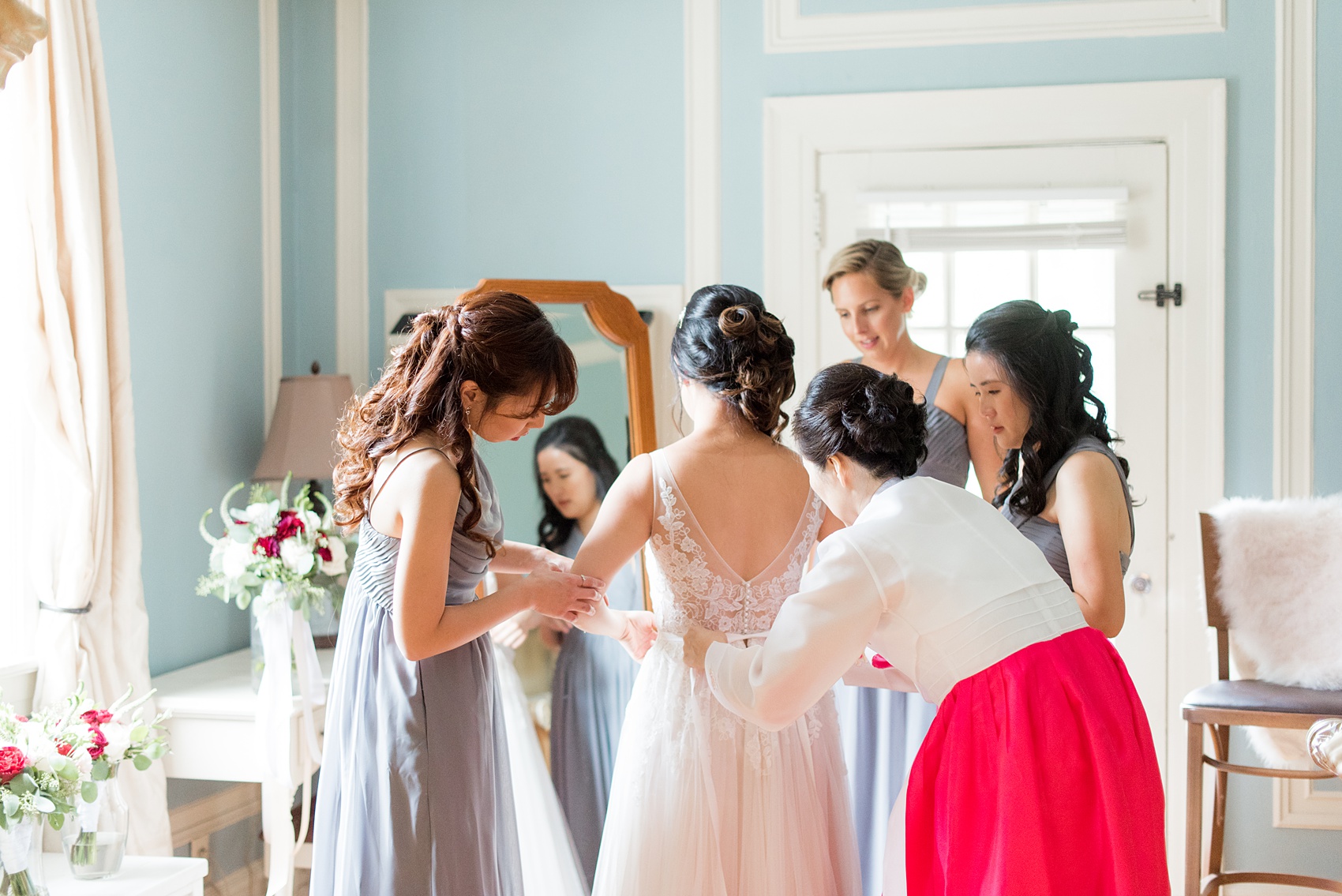 Wedding photos at Crabtree's Kittle House in Chappaqua, New York by Mikkel Paige Photography. The bride's mother, bridesmaid and sister (Maid of Honor) helped her tie her wedding gown bow at this Westchester County historic home. Click through to see more photos from this gorgeous day! #mikkelpaige #CrabtreesKittleHouse #AsianWeddingTraditions #WestchesterWeddingVenues #WestchesterWedding #summerwedding #weddingdetails #bride #gettingready #weddinggettingready #historichome 