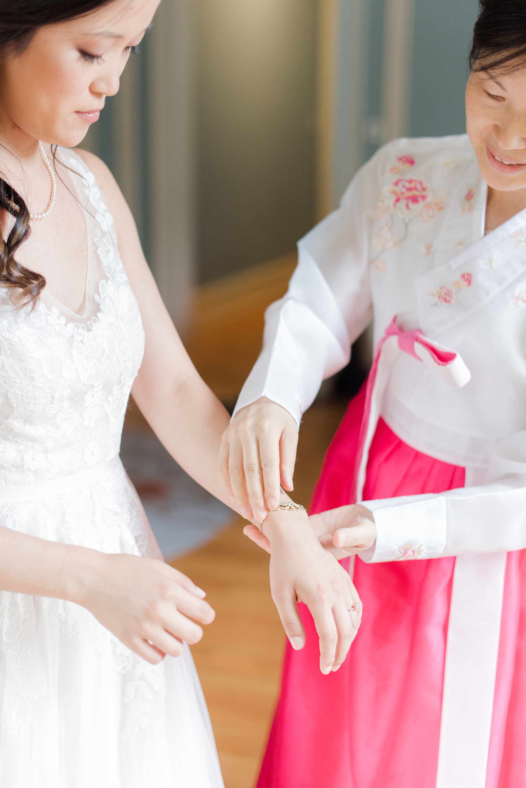 Wedding photos at Crabtree's Kittle House in Chappaqua, New York by Mikkel Paige Photography. The bride, her mother and bridesmaids got ready on location and her mom helped her put on a special gifted gold and diamond bracelet. Click through to see more photos from this gorgeous day! #mikkelpaige #CrabtreesKittleHouse #AsianWeddingTraditions #WestchesterWeddingVenues #WestchesterWedding #summerwedding #weddingdetails #bride #gettingready #weddinggettingready #motherofthebride