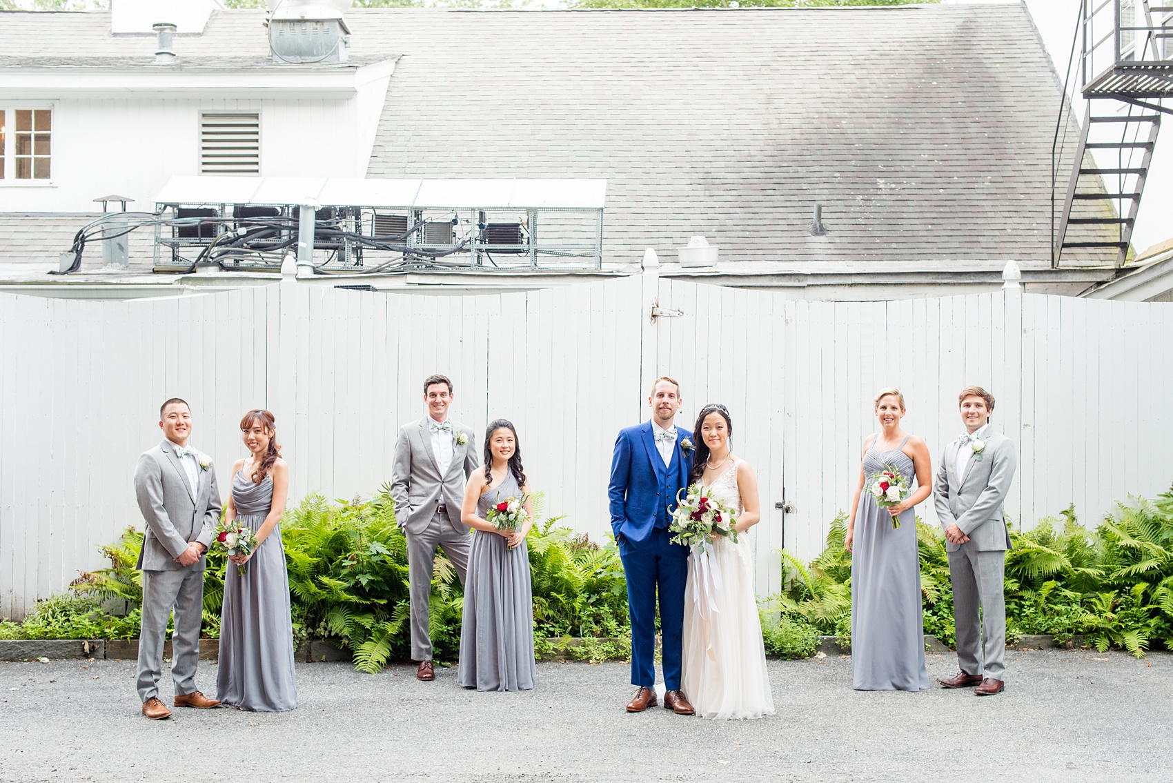 Wedding photos at Crabtree's Kittle House in Chappaqua, New York by Mikkel Paige Photography. This venue in Westchester county was the perfect place to capture their creative Vogue-like bridal party photo, with the bridesmaids in grey gowns and men in grey suits with matching pattern bow ties. The historic home is very close to NYC. Click through for more summer wedding inspiration from their day! #bluesuit #BHLDNgown #mikkelpaige #CrabtreesKittleHouse #WestchesterWeddingVenues #WestchesterWedding #AsianBride #summerwedding #brideandgroom #weddingparty #bridalparty #vogueweddingphotos