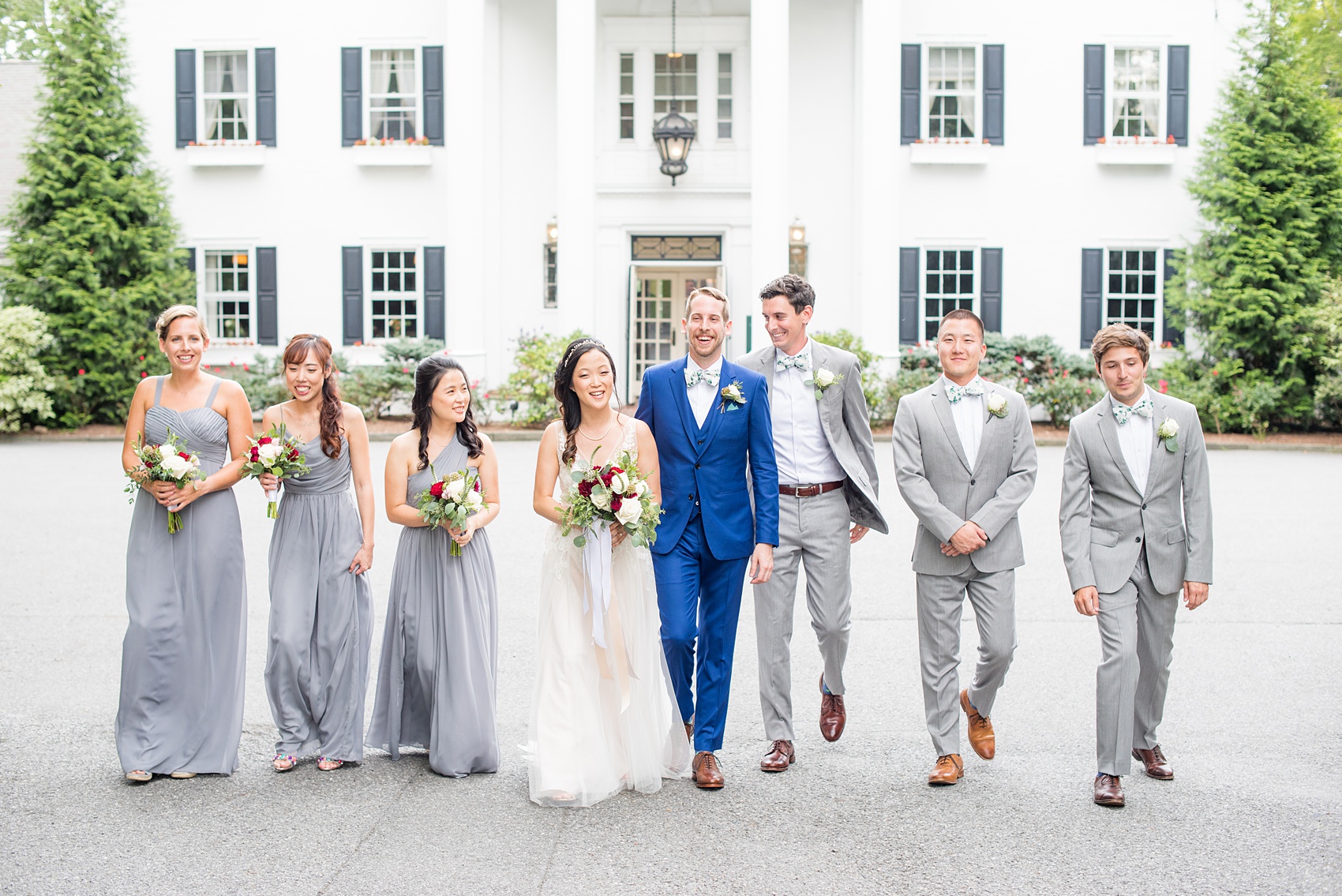 Wedding photos at Crabtree's Kittle House in Chappaqua, New York by Mikkel Paige Photography. This venue in Westchester county was the perfect place to capture their creative Vogue-like bridal party photo, with the bridesmaids in grey gowns and men in grey suits with matching pattern bow ties. The historic home is very close to NYC. Click through for more summer wedding inspiration from their day! #bluesuit #BHLDNgown #mikkelpaige #CrabtreesKittleHouse #WestchesterWeddingVenues #WestchesterWedding #AsianBride #summerwedding #brideandgroom #weddingparty #bridalparty #vogueweddingphotos