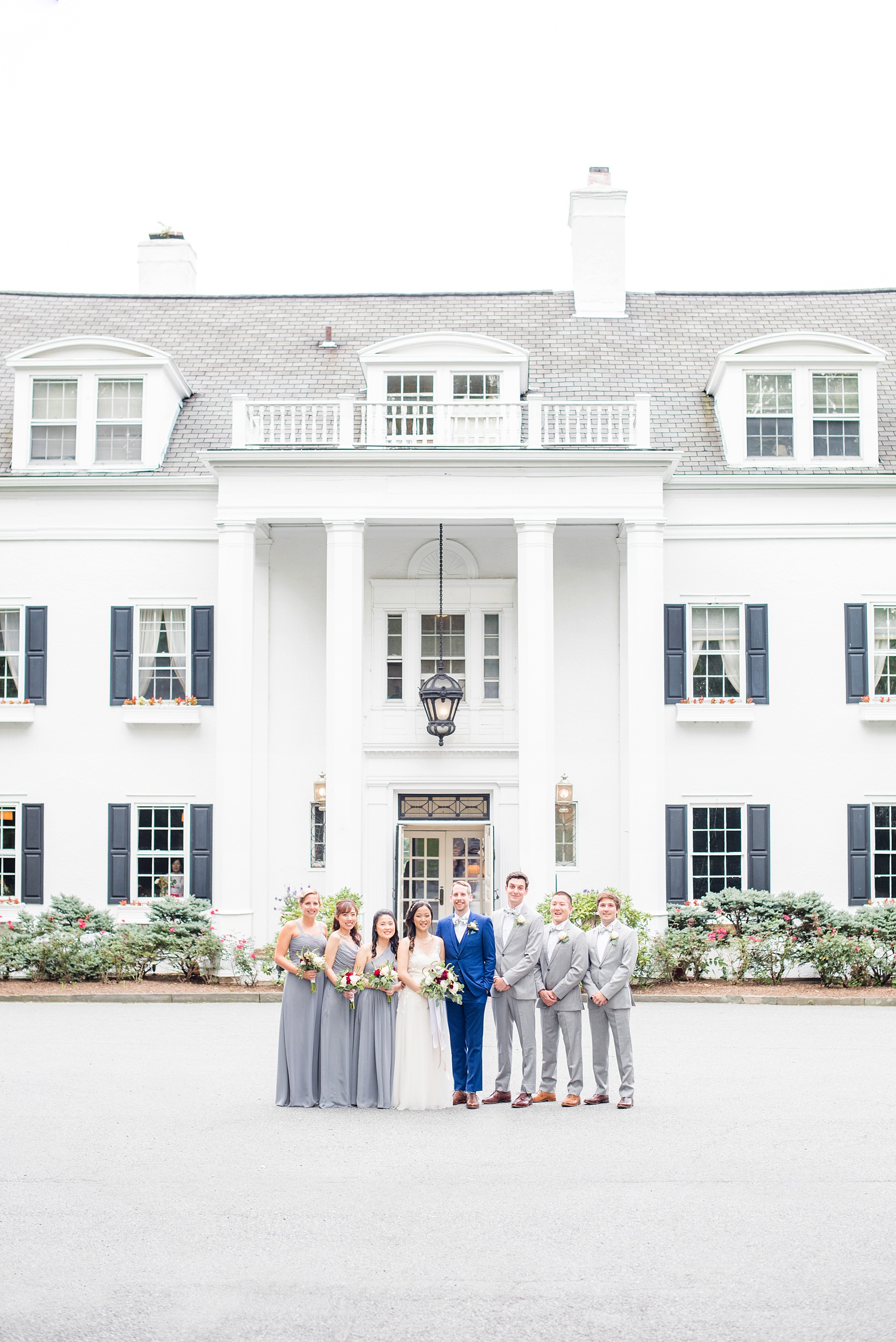 Wedding photos at Crabtree's Kittle House in Chappaqua, New York by Mikkel Paige Photography. This venue in Westchester county was the perfect place to capture their creative Vogue-like bridal party photo, with the bridesmaids in grey gowns and men in grey suits with matching pattern bow ties. The historic home is very close to NYC. Click through for more summer wedding inspiration from their day! #bluesuit #BHLDNgown #mikkelpaige #CrabtreesKittleHouse #WestchesterWeddingVenues #WestchesterWedding #AsianBride #summerwedding #brideandgroom #weddingparty #bridalparty #vogueweddingphotos