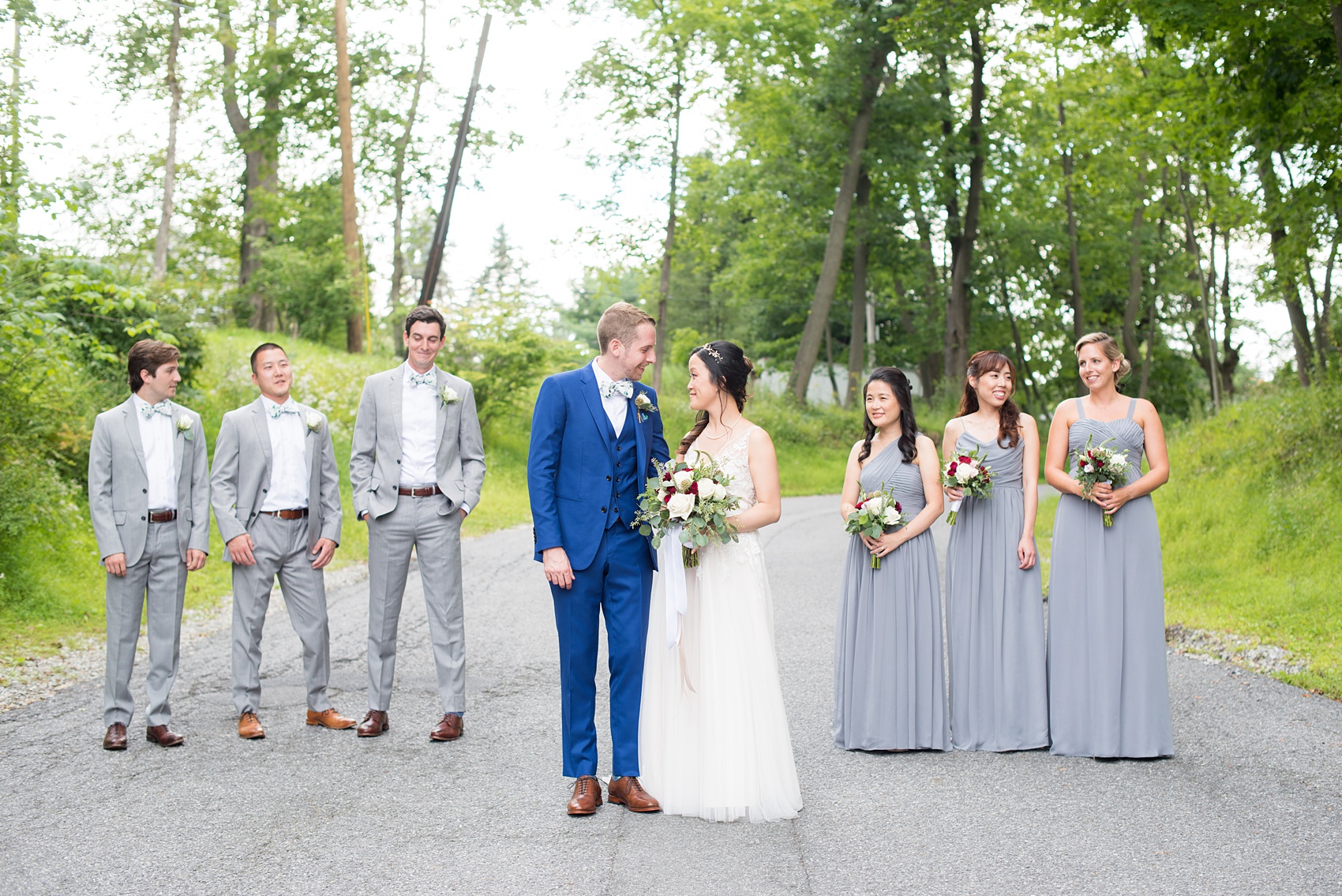 Wedding photos at Crabtree's Kittle House in Chappaqua, New York by Mikkel Paige Photography. This venue in Westchester county was the perfect place to capture their creative Vogue-like bridal party photo, with the bridesmaids in grey gowns and men in grey suits with matching pattern bow ties. The historic home is very close to NYC. Click through for more summer wedding inspiration from their day! #bluesuit #BHLDNgown #mikkelpaige #CrabtreesKittleHouse #WestchesterWeddingVenues #WestchesterWedding #AsianBride #summerwedding #brideandgroom #weddingparty #bridalparty #vogueweddingphotos