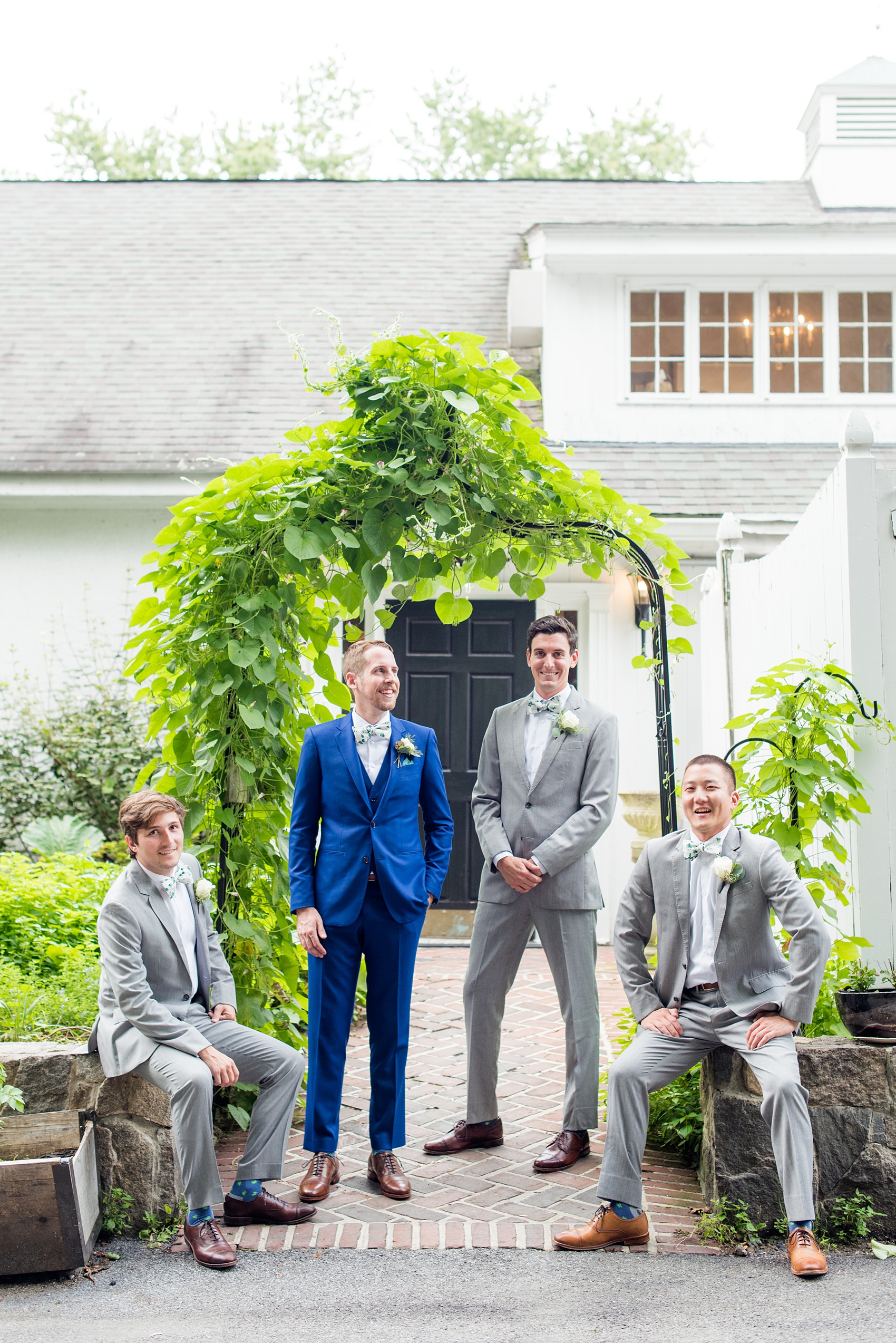 Wedding photos at Crabtree's Kittle House in Chappaqua, New York by Mikkel Paige Photography. This venue in Westchester county was a beautiful location to capture summer wedding pictures, with the groomsmen in grey suits and matching green and white pattern bow ties. The groom wore a custom blue suit. The historic home is very close to NYC and great for a wedding outside the city. Click through for more wedding inspiration from their day! #mikkelpaige #CrabtreesKittleHouse #WestchesterWeddingVenues #WestchesterWedding #summerwedding #groomsmen #weddingparty #patternbowties 