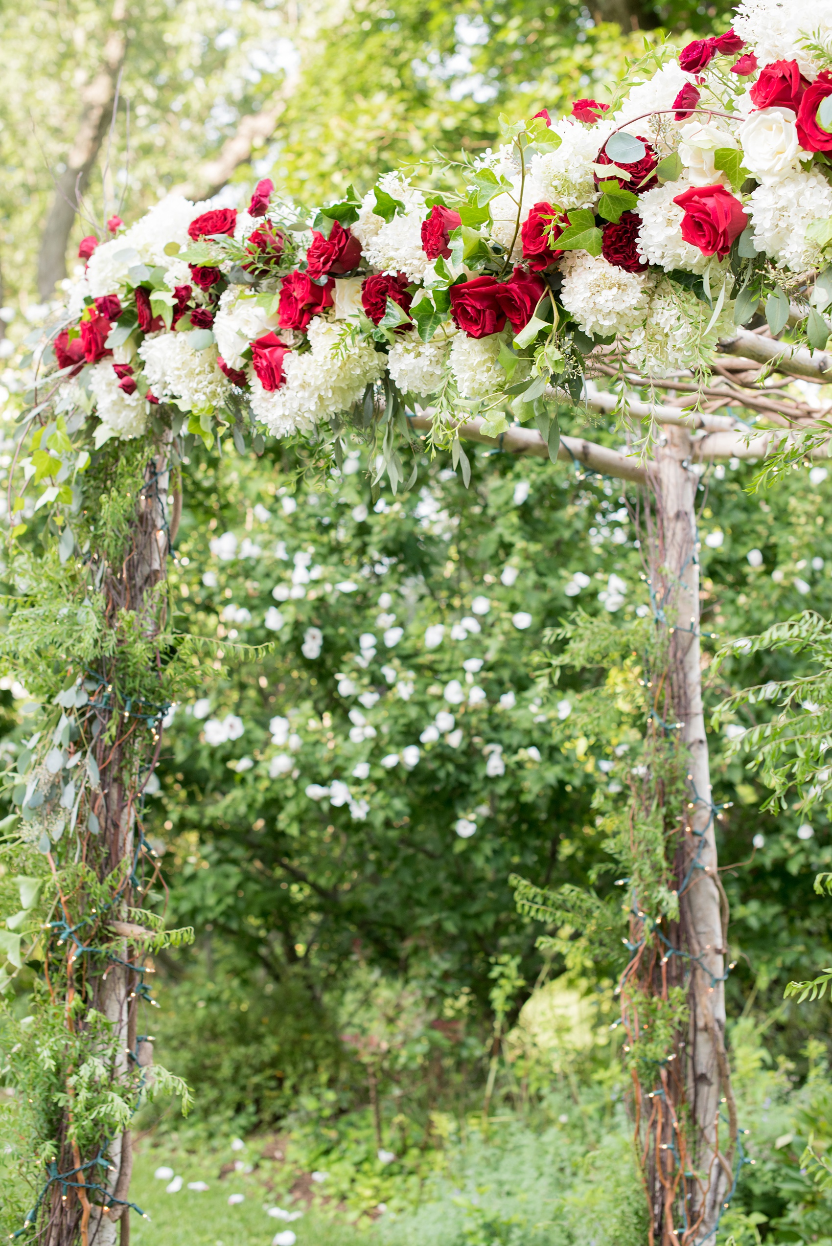 Wedding photos at Crabtree's Kittle House in Chappaqua, New York by Mikkel Paige Photography. This venue in Westchester county is a beautiful location for an outdoor summer wedding. The ceremony was overlooking pretty scenery and the couple got married under a branch chuppah/arbor decorated with red and white flowers. Click through for more inspiration from their day! #mikkelpaige #CrabtreesKittleHouse #WestchesterWeddingVenues #WestchesterWedding #summerwedding #weddingceremony #weddingaltar #chuppah #outdoorceremony