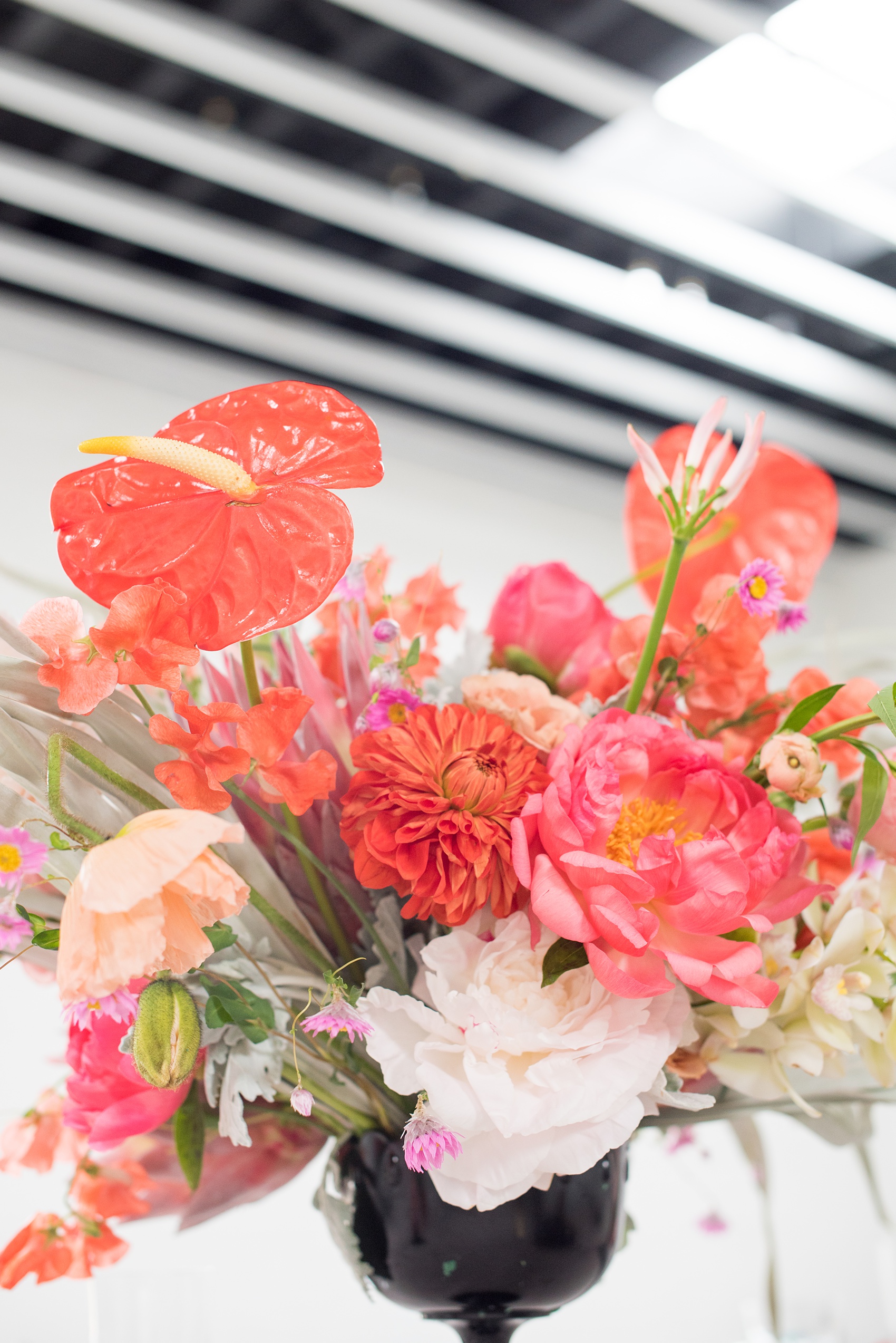 Palm Springs inspired wedding ideas with photos by Mikkel Paige Photography, NYC photographer. The pictures of this beautiful, tropical floral centerpiece in a black vase was created by Sachi Rose Designs. Planning by Color Pop Events for a shoot with Love Inc. Mag. #PalmSpringsInspiration #PalmSpringsWedding #Midcenturymodern