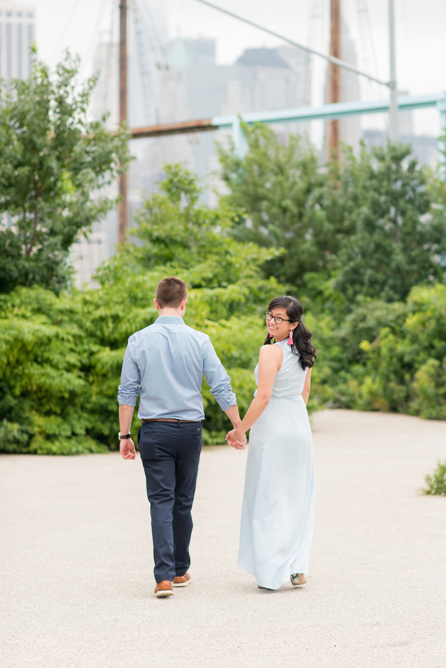 Brooklyn engagement photos by Mikkel Paige Photography. These beautiful, love-filled images in the park overlook bridges, the Manhattan skyline and waterfront on Piers 5 and 6. They'll provide inspiration from the bride and groom for outfits, romantic picture ideas and all around feel-good smiles! Click through to see their complete session post! #mikkelpaige #NYCweddingphotographer #NYCengagementsession #brooklynengagementphotos #engagementphotosinBrooklyn #BrooklynBridgePark #BrooklynPiers #ManhattanSkyline #BrooklynBridge #cityengagementphotos