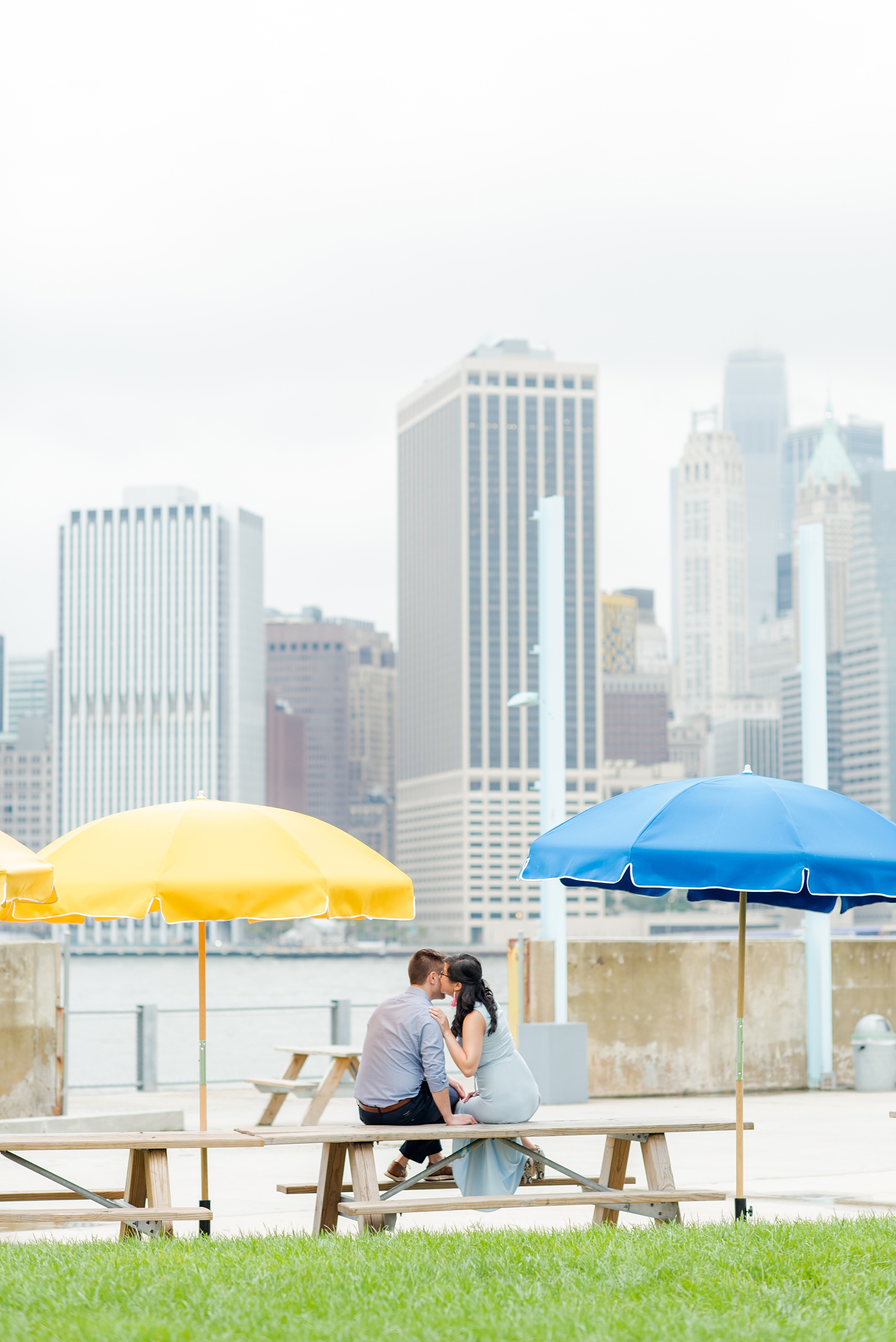 Brooklyn engagement photos by Mikkel Paige Photography. These beautiful, love-filled images in the park overlook bridges, the Manhattan skyline and waterfront on Piers 5 and 6. They'll provide inspiration from the bride and groom for outfits, romantic picture ideas and all around feel-good smiles! Click through to see their complete session post! #mikkelpaige #NYCweddingphotographer #NYCengagementsession #brooklynengagementphotos #engagementphotosinBrooklyn #BrooklynBridgePark #BrooklynPiers #ManhattanSkyline #BrooklynBridge #cityengagementphotos