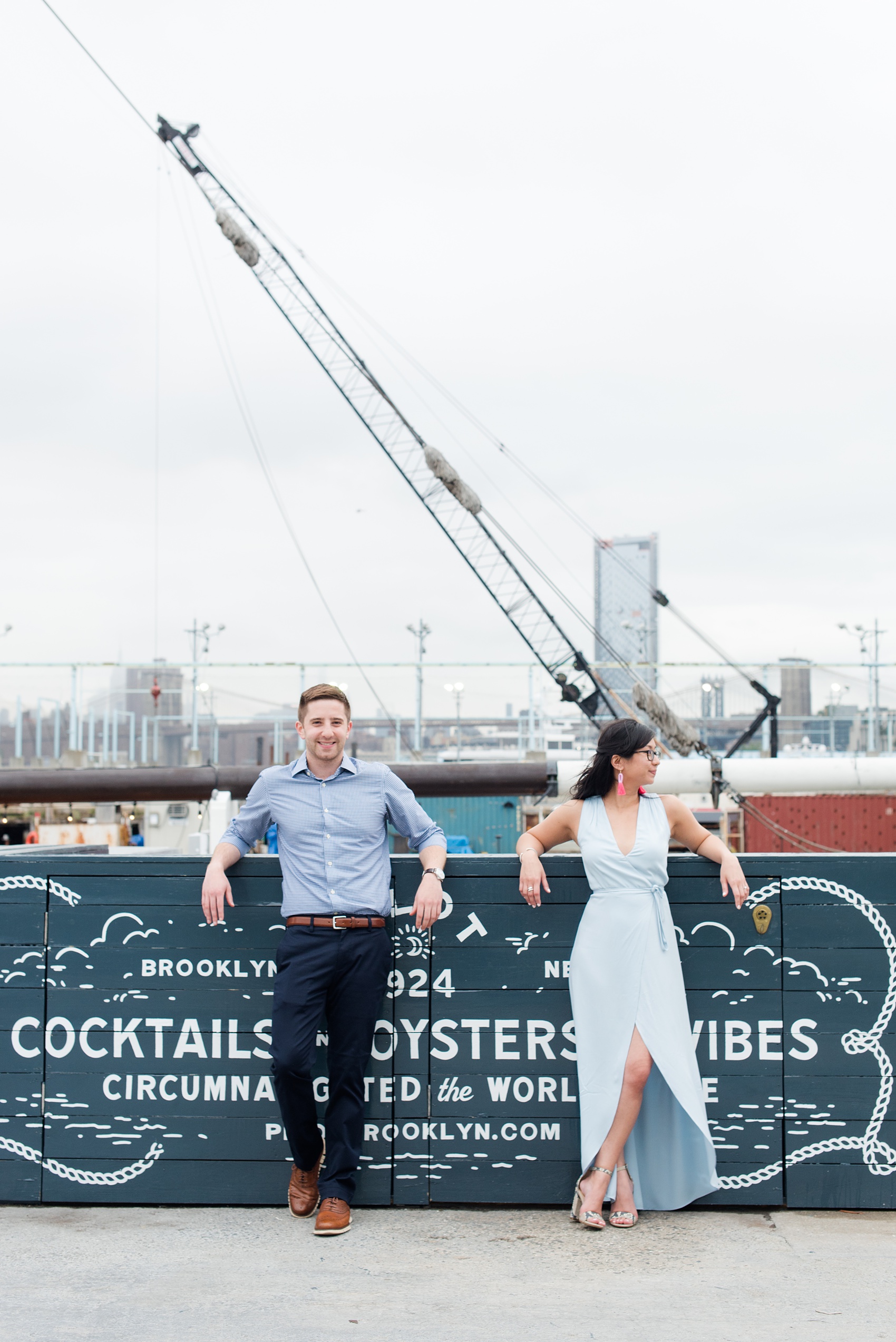 Brooklyn engagement photos by Mikkel Paige Photography. These beautiful, love-filled images in the park overlook bridges, the Manhattan skyline and waterfront on Piers 5 and 6. They'll provide inspiration from the bride and groom for outfits, romantic picture ideas and all around feel-good smiles! Click through to see their complete session post! #mikkelpaige #NYCweddingphotographer #NYCengagementsession #brooklynengagementphotos #engagementphotosinBrooklyn #BrooklynBridgePark #BrooklynPiers #ManhattanSkyline #BrooklynBridge #cityengagementphotos