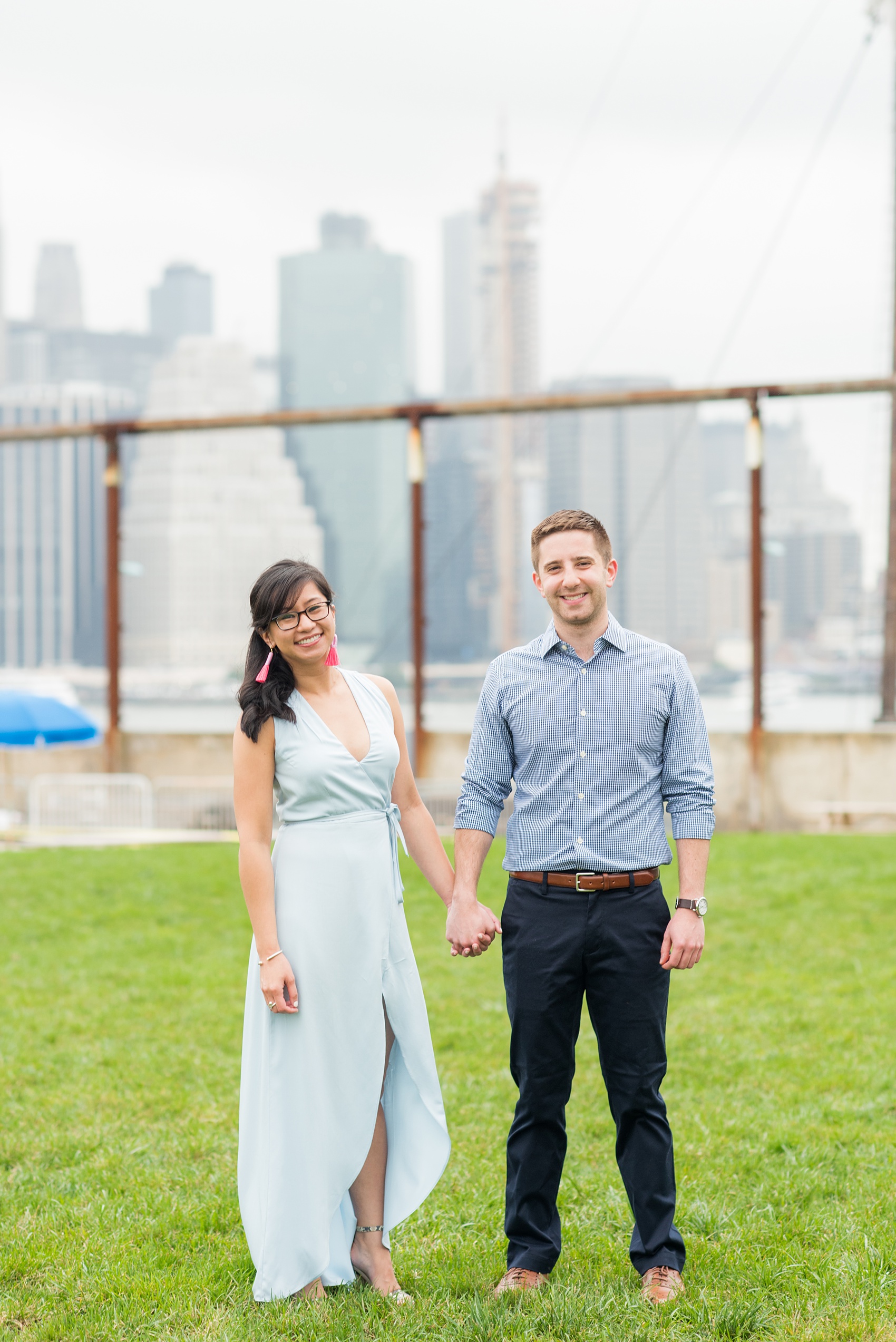 Brooklyn engagement photos by Mikkel Paige Photography. These beautiful, love-filled images in the park overlook bridges, the Manhattan skyline and waterfront on Piers 5 and 6. They'll provide inspiration from the bride and groom for outfits, romantic picture ideas and all around feel-good smiles! Click through to see their complete session post! #mikkelpaige #NYCweddingphotographer #NYCengagementsession #brooklynengagementphotos #engagementphotosinBrooklyn #BrooklynBridgePark #BrooklynPiers #ManhattanSkyline #BrooklynBridge #cityengagementphotos