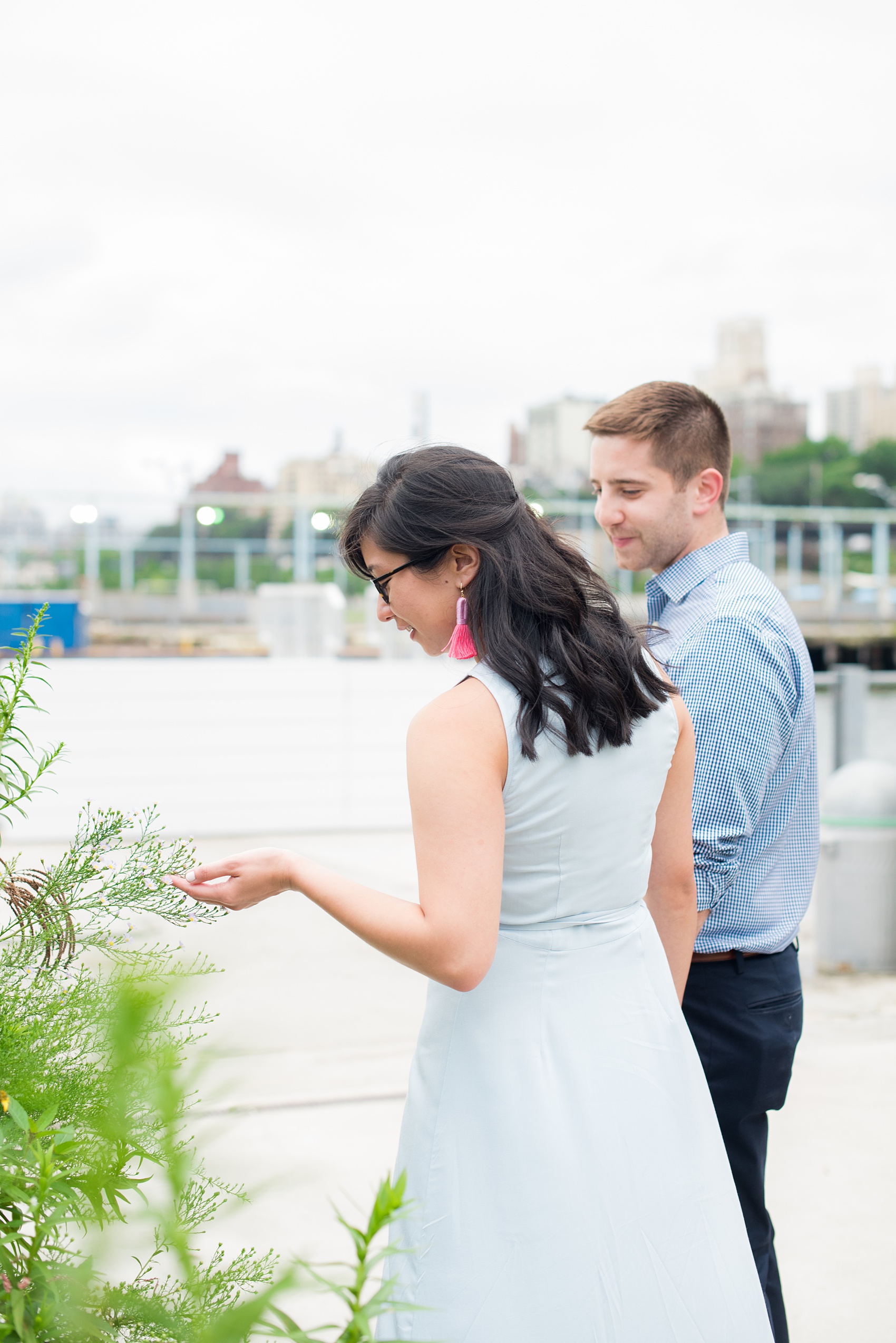Brooklyn engagement photos by Mikkel Paige Photography. These beautiful, love-filled images in the park overlook bridges, the Manhattan skyline and waterfront on Piers 5 and 6. They'll provide inspiration from the bride and groom for outfits, romantic picture ideas and all around feel-good smiles! Click through to see their complete session post! #mikkelpaige #NYCweddingphotographer #NYCengagementsession #brooklynengagementphotos #engagementphotosinBrooklyn #BrooklynBridgePark #BrooklynPiers #ManhattanSkyline #BrooklynBridge #cityengagementphotos