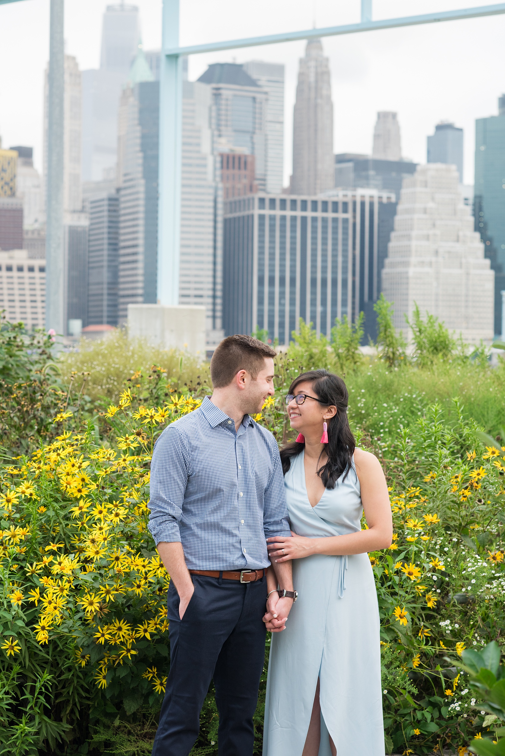 Brooklyn engagement photos by Mikkel Paige Photography. These beautiful, love-filled images in the park overlook bridges, the Manhattan skyline and waterfront on Piers 5 and 6. They'll provide inspiration from the bride and groom for outfits, romantic picture ideas and all around feel-good smiles! Click through to see their complete session post! #mikkelpaige #NYCweddingphotographer #NYCengagementsession #brooklynengagementphotos #engagementphotosinBrooklyn #BrooklynBridgePark #BrooklynPiers #ManhattanSkyline #BrooklynBridge #cityengagementphotos