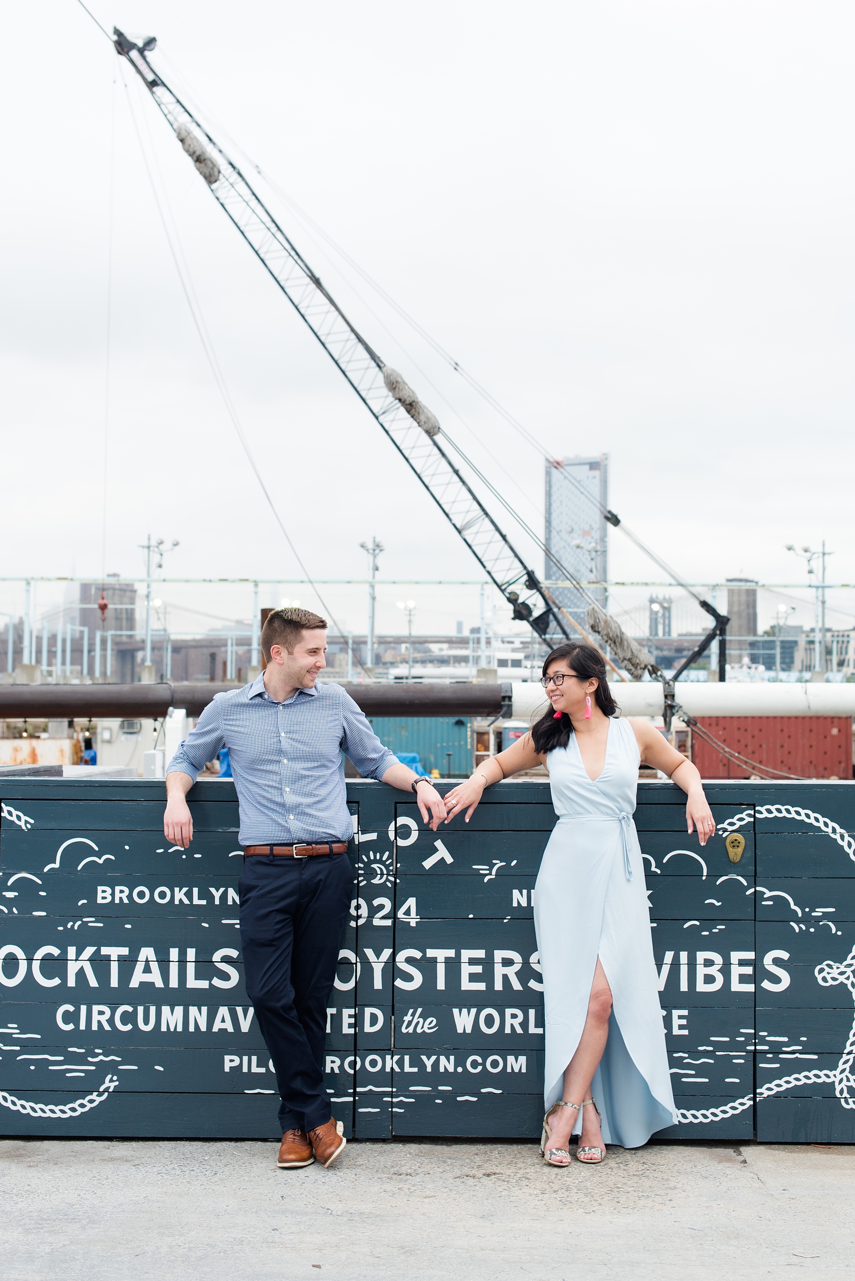 Brooklyn engagement photos by Mikkel Paige Photography. These beautiful, love-filled images in the park overlook bridges, the Manhattan skyline and waterfront on Piers 5 and 6. They'll provide inspiration from the bride and groom for outfits, romantic picture ideas and all around feel-good smiles! Click through to see their complete session post! #mikkelpaige #NYCweddingphotographer #NYCengagementsession #brooklynengagementphotos #engagementphotosinBrooklyn #BrooklynBridgePark #BrooklynPiers #ManhattanSkyline #BrooklynBridge #cityengagementphotos