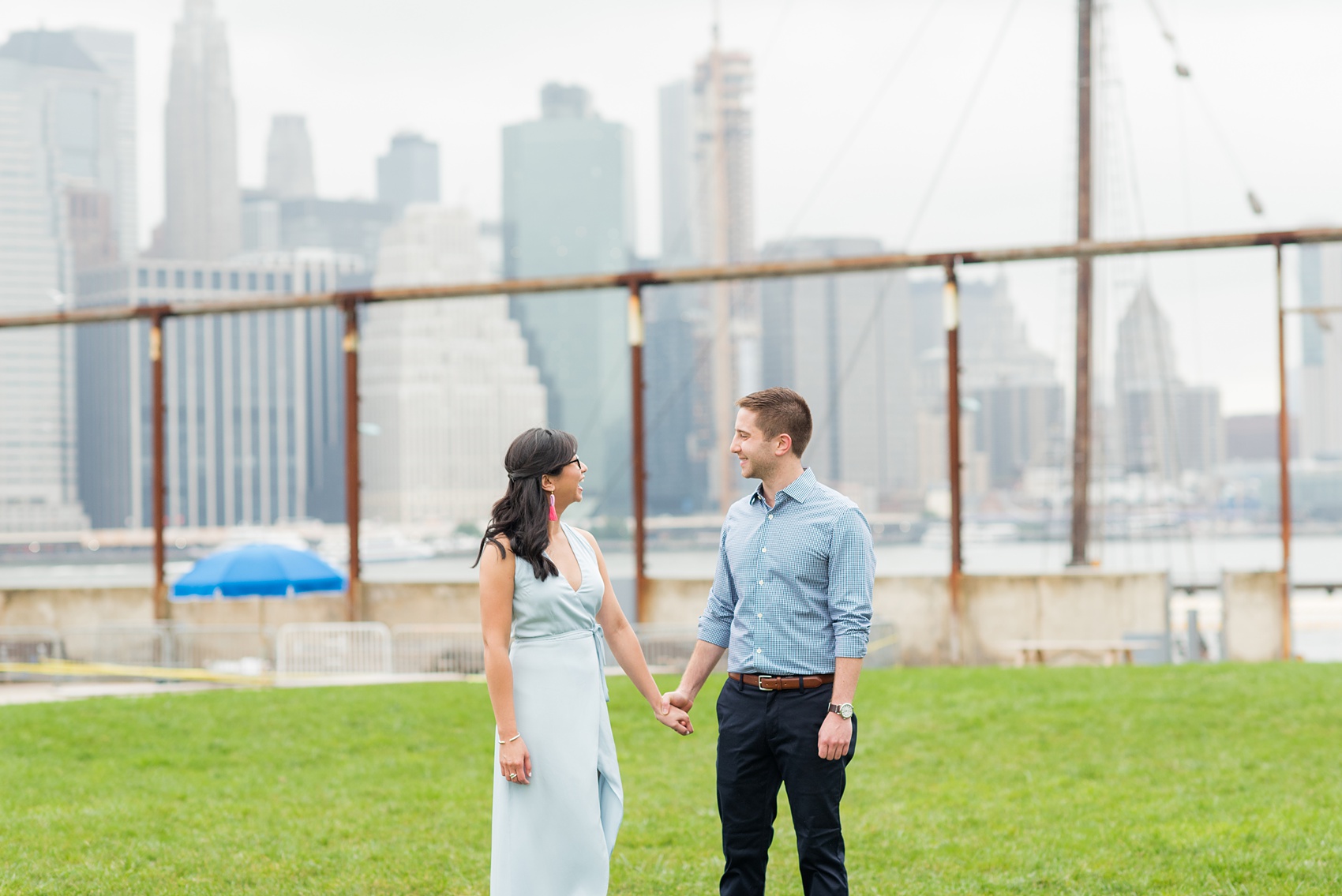 Brooklyn engagement photos by Mikkel Paige Photography. These beautiful, love-filled images in the park overlook bridges, the Manhattan skyline and waterfront on Piers 5 and 6. They'll provide inspiration from the bride and groom for outfits, romantic picture ideas and all around feel-good smiles! Click through to see their complete session post! #mikkelpaige #NYCweddingphotographer #NYCengagementsession #brooklynengagementphotos #engagementphotosinBrooklyn #BrooklynBridgePark #BrooklynPiers #ManhattanSkyline #BrooklynBridge #cityengagementphotos