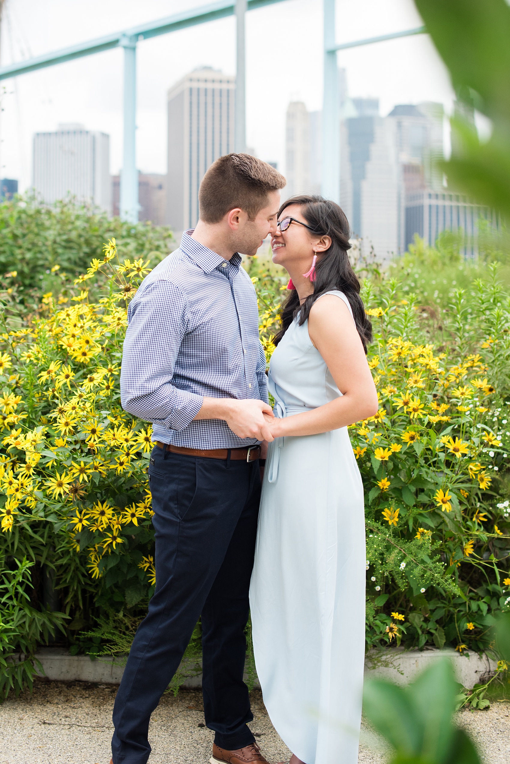 Brooklyn engagement photos by Mikkel Paige Photography. These beautiful, love-filled images in the park overlook bridges, the Manhattan skyline and waterfront on Piers 5 and 6. They'll provide inspiration from the bride and groom for outfits, romantic picture ideas and all around feel-good smiles! Click through to see their complete session post! #mikkelpaige #NYCweddingphotographer #NYCengagementsession #brooklynengagementphotos #engagementphotosinBrooklyn #BrooklynBridgePark #BrooklynPiers #ManhattanSkyline #BrooklynBridge #cityengagementphotos