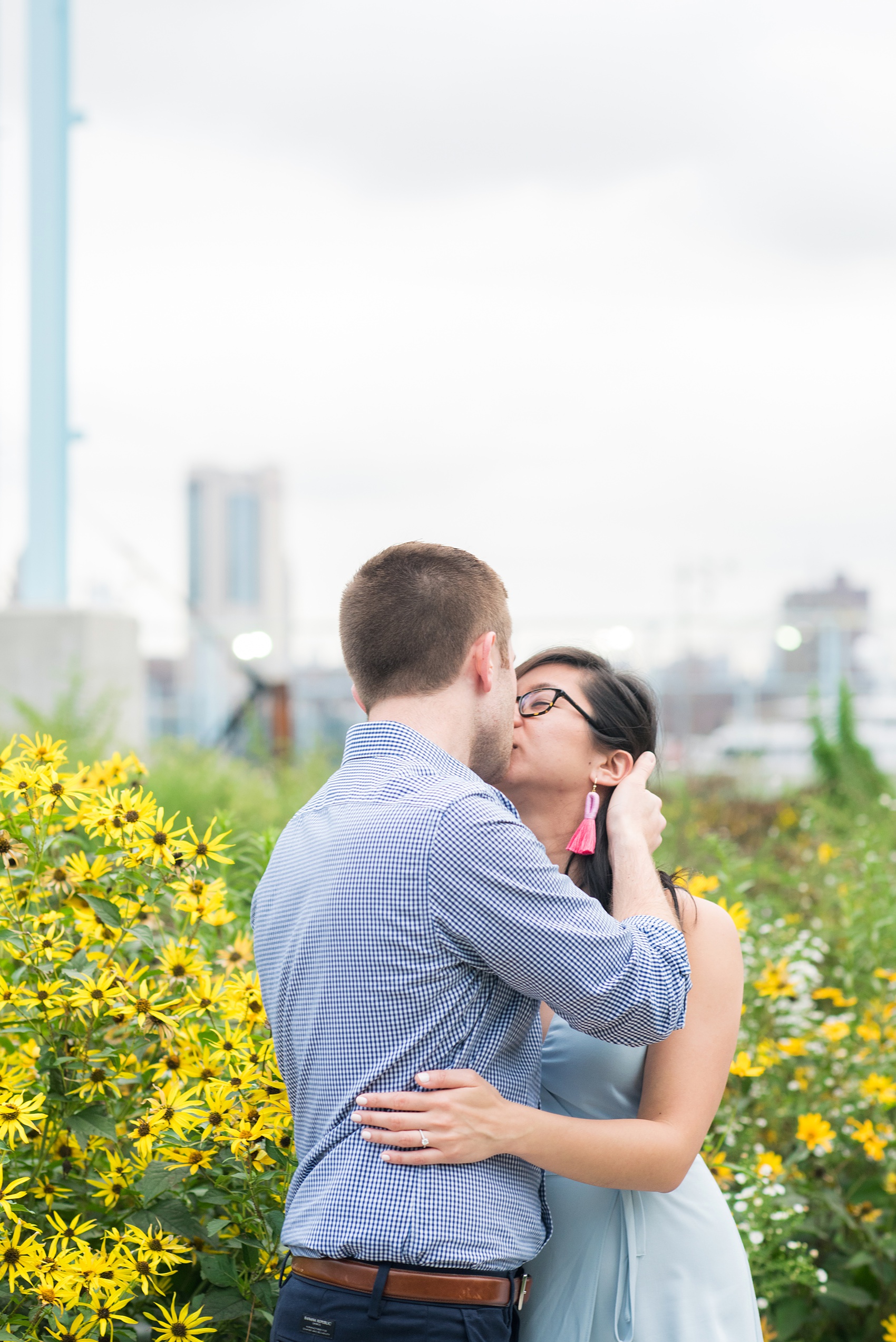 Brooklyn engagement photos by Mikkel Paige Photography. These beautiful, love-filled images in the park overlook bridges, the Manhattan skyline and waterfront on Piers 5 and 6. They'll provide inspiration from the bride and groom for outfits, romantic picture ideas and all around feel-good smiles! Click through to see their complete session post! #mikkelpaige #NYCweddingphotographer #NYCengagementsession #brooklynengagementphotos #engagementphotosinBrooklyn #BrooklynBridgePark #BrooklynPiers #ManhattanSkyline #BrooklynBridge #cityengagementphotos