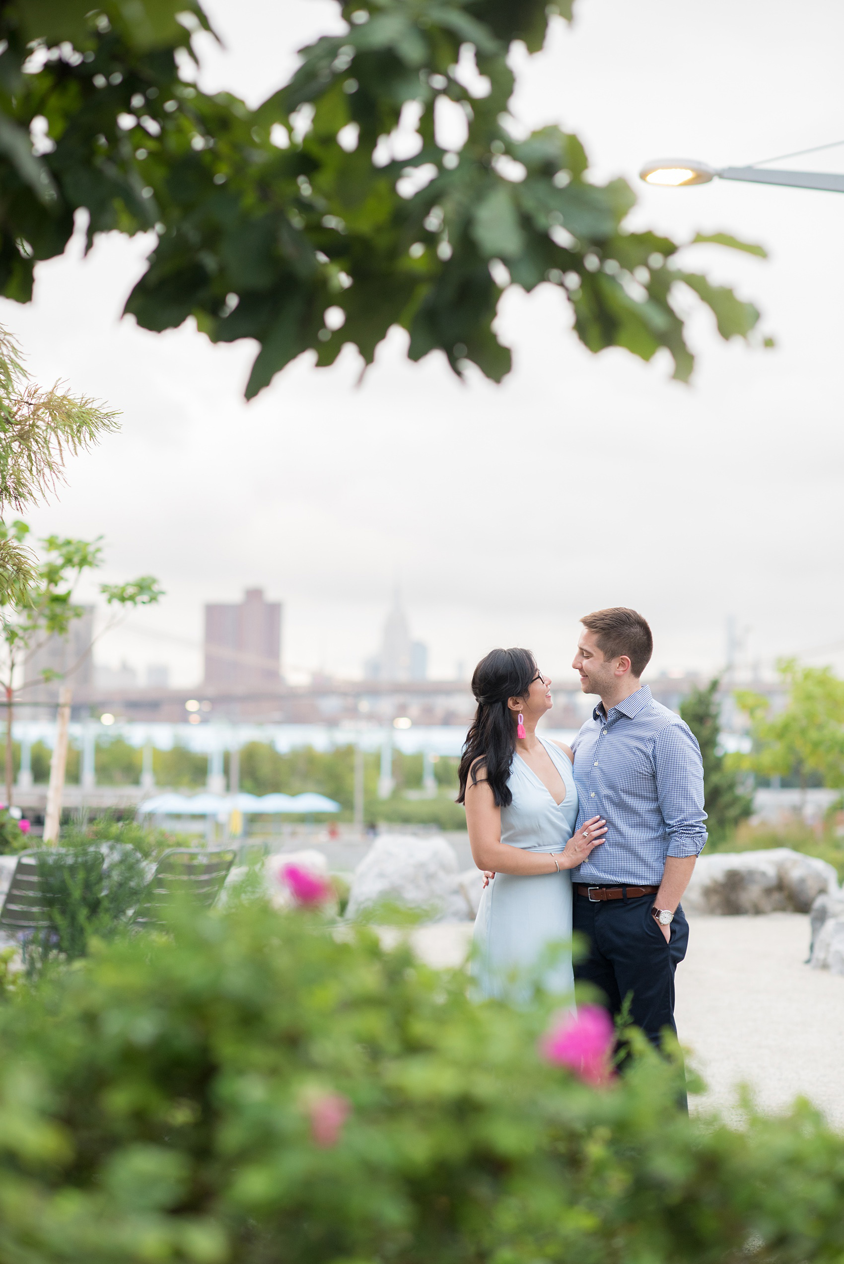 Brooklyn engagement photos by Mikkel Paige Photography. These beautiful, love-filled images in the park overlook bridges, the Manhattan skyline and waterfront on Piers 5 and 6. They'll provide inspiration from the bride and groom for outfits, romantic picture ideas and all around feel-good smiles! Click through to see their complete session post! #mikkelpaige #NYCweddingphotographer #NYCengagementsession #brooklynengagementphotos #engagementphotosinBrooklyn #BrooklynBridgePark #BrooklynPiers #ManhattanSkyline #BrooklynBridge #cityengagementphotos