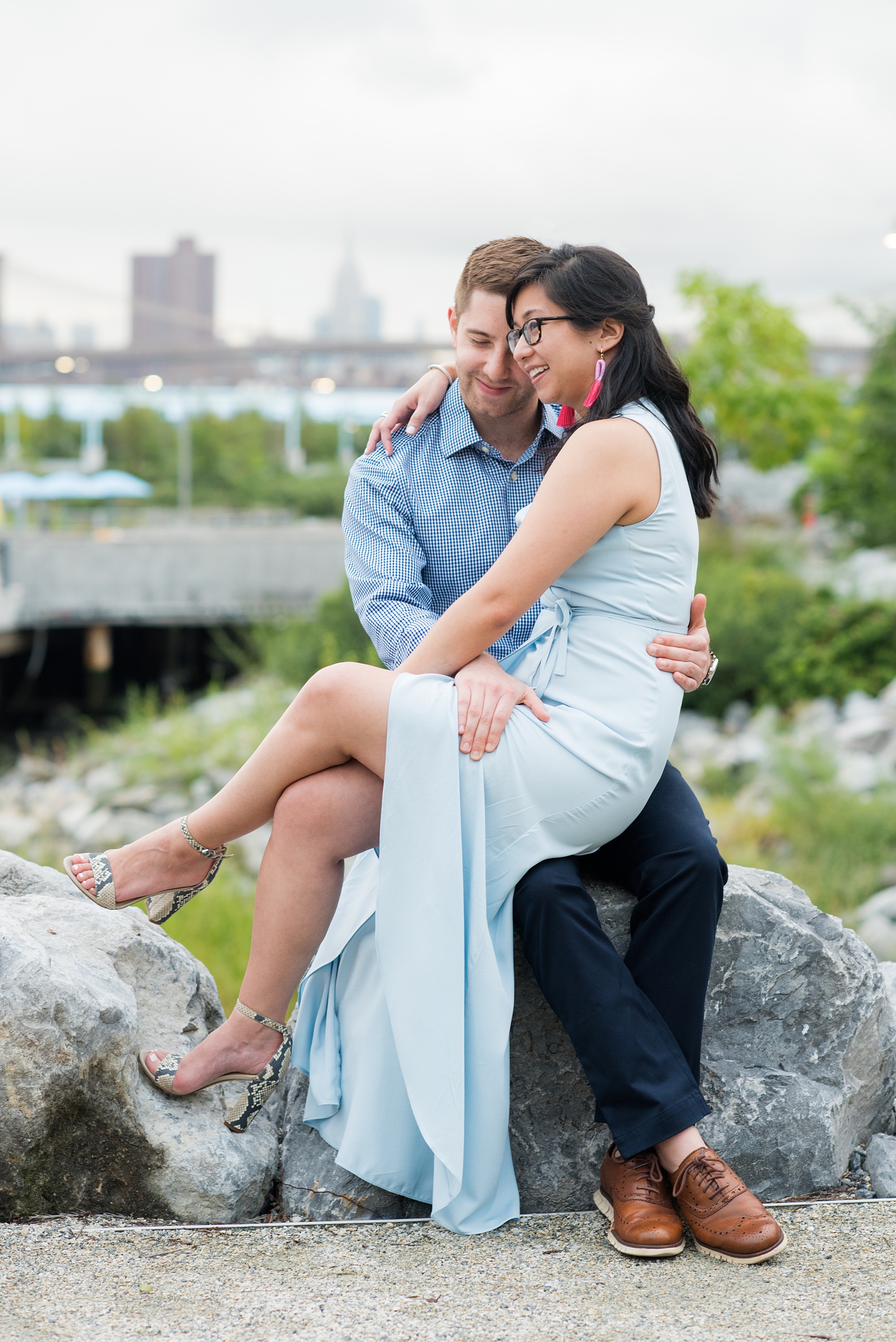 Brooklyn engagement photos by Mikkel Paige Photography. These beautiful, love-filled images in the park overlook bridges, the Manhattan skyline and waterfront on Piers 5 and 6. They'll provide inspiration from the bride and groom for outfits, romantic picture ideas and all around feel-good smiles! Click through to see their complete session post! #mikkelpaige #NYCweddingphotographer #NYCengagementsession #brooklynengagementphotos #engagementphotosinBrooklyn #BrooklynBridgePark #BrooklynPiers #ManhattanSkyline #BrooklynBridge #cityengagementphotos