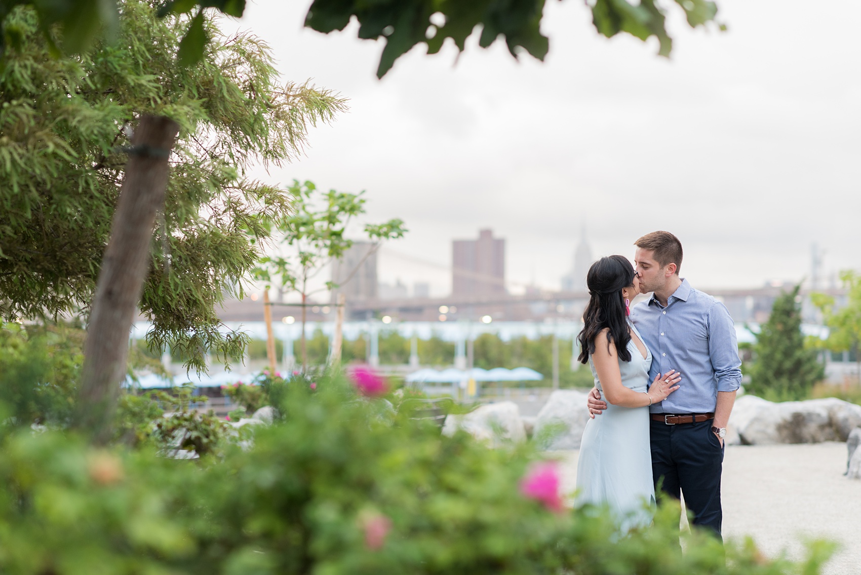 Brooklyn engagement photos by Mikkel Paige Photography. These beautiful, love-filled images in the park overlook bridges, the Manhattan skyline and waterfront on Piers 5 and 6. They'll provide inspiration from the bride and groom for outfits, romantic picture ideas and all around feel-good smiles! Click through to see their complete session post! #mikkelpaige #NYCweddingphotographer #NYCengagementsession #brooklynengagementphotos #engagementphotosinBrooklyn #BrooklynBridgePark #BrooklynPiers #ManhattanSkyline #BrooklynBridge #cityengagementphotos