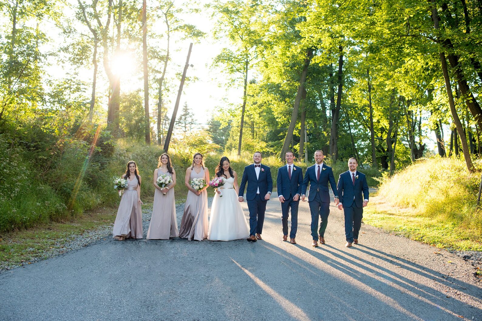 Wedding photos at Crabtree's Kittle House in Chappaqua, New York by Mikkel Paige Photography. This venue in Westchester county is the perfect place for a September wedding. Golden hour shone down on the bridal party in dusty rose gowns and groomsmen in navy blue suits. Click through for more wedding photos from the day! #navybluesuit #mikkelpaige #CrabtreesKittleHouse #WestchesterWeddingVenues #WestchesterWedding #Septemberwedding #weddingparty #BridalParty #goldenhour #dustyrose