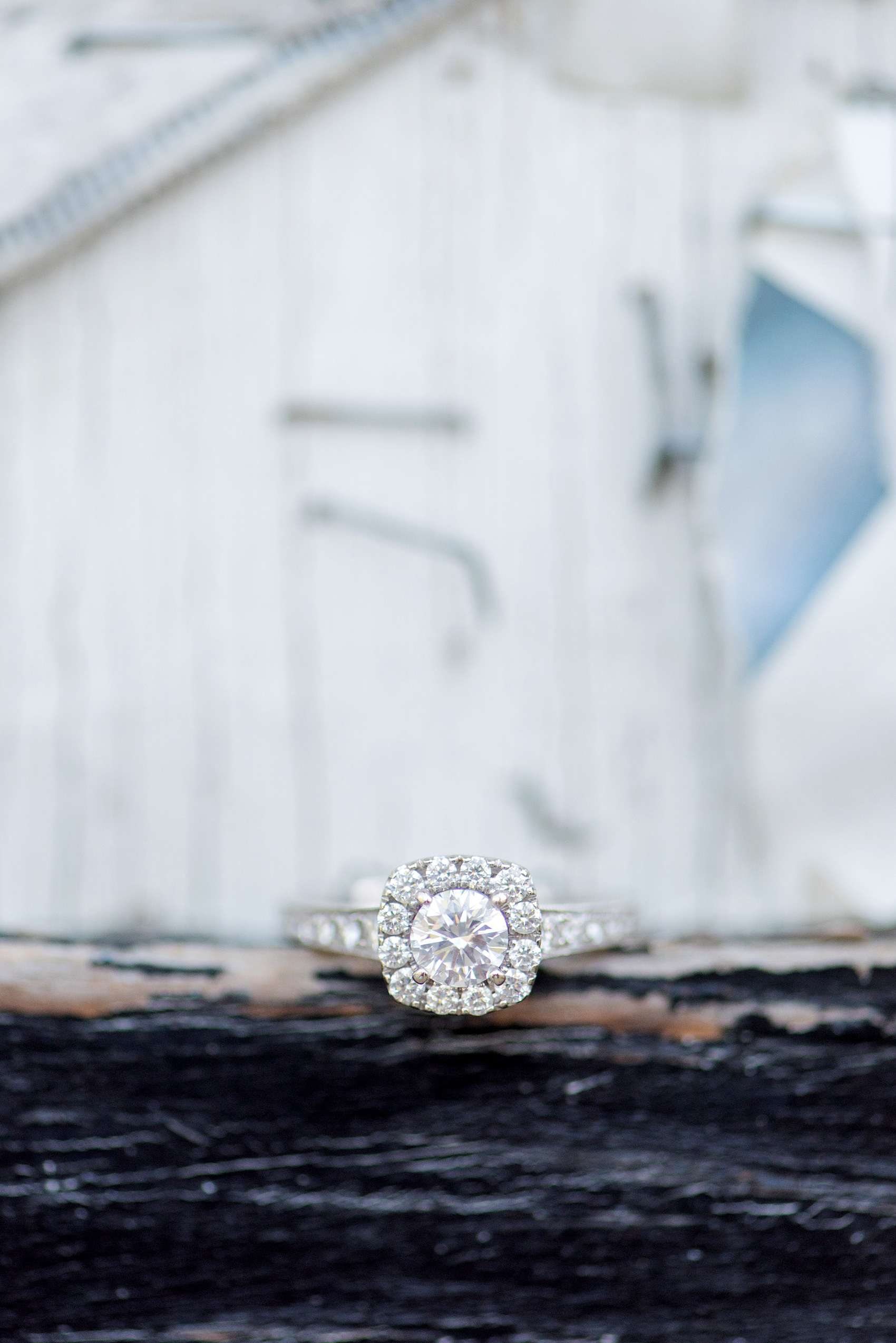 Urban engagement photos in downtown Durham, North Carolina, by Mikkel Paige Photography. The bride has a diamond engagement ring with a halo square and round center stone and filigree detail on the band. #DurhamWeddingPhotographer #RaleighWeddingPhotographer #DurhamEngagementPhotos #urbanengagementphotos #cityengagementsession #cityengagementphotos #filigree #engagementring #halosetting