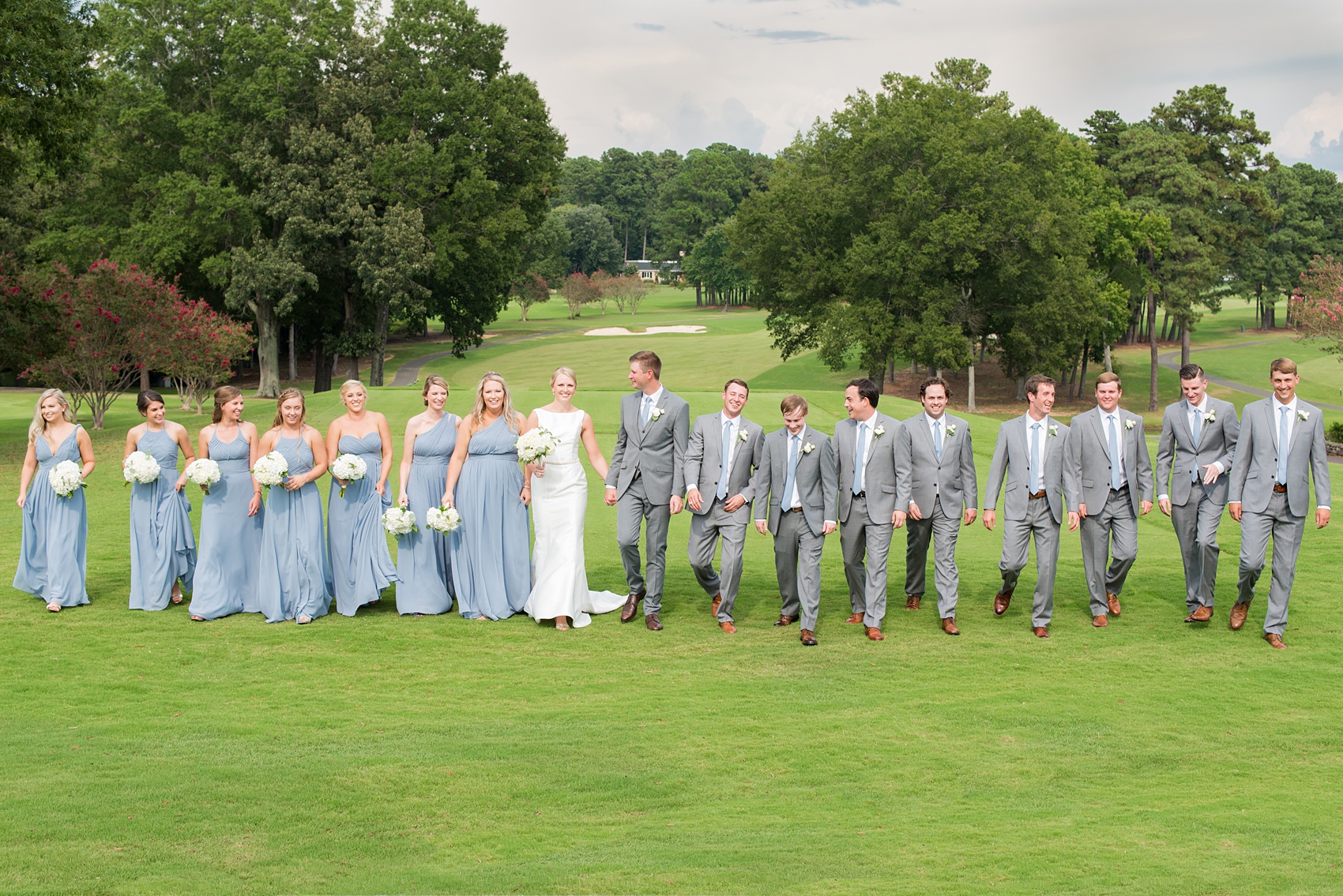 Pictures by Durham wedding photographer, Mikkel Paige Photography, in North Carolina. The beautiful white flowers from the days events, pretty garden-like golf course at Croasdaile Country Club and various photo ideas with the bridesmaids in blue and bride in a low-back gown will inspire you! Click through to our website for the complete post and details. #durhamNC #northcarolinawedding #southernwedding #golfcoursewedding #CountryClubWedding #bluebridesmaids #DurhamWedding #summerwedding