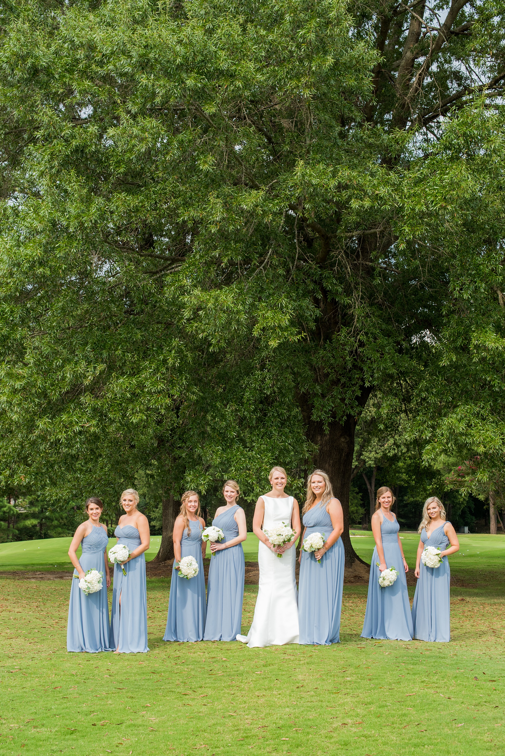 Pictures by Mikkel Paige Photography of a wedding in Durham, North Carolina. The beautiful white flowers from the days events, pretty garden-like golf course at Croasdaile Country Club and various photo ideas with the bridesmaids in blue and bride in a low-back gown will inspire you! Click through to our website for the complete post and details. #durhamNC #northcarolinawedding #southernwedding #golfcoursewedding #CountryClubWedding #bluebridesmaids #DurhamWedding #summerwedding