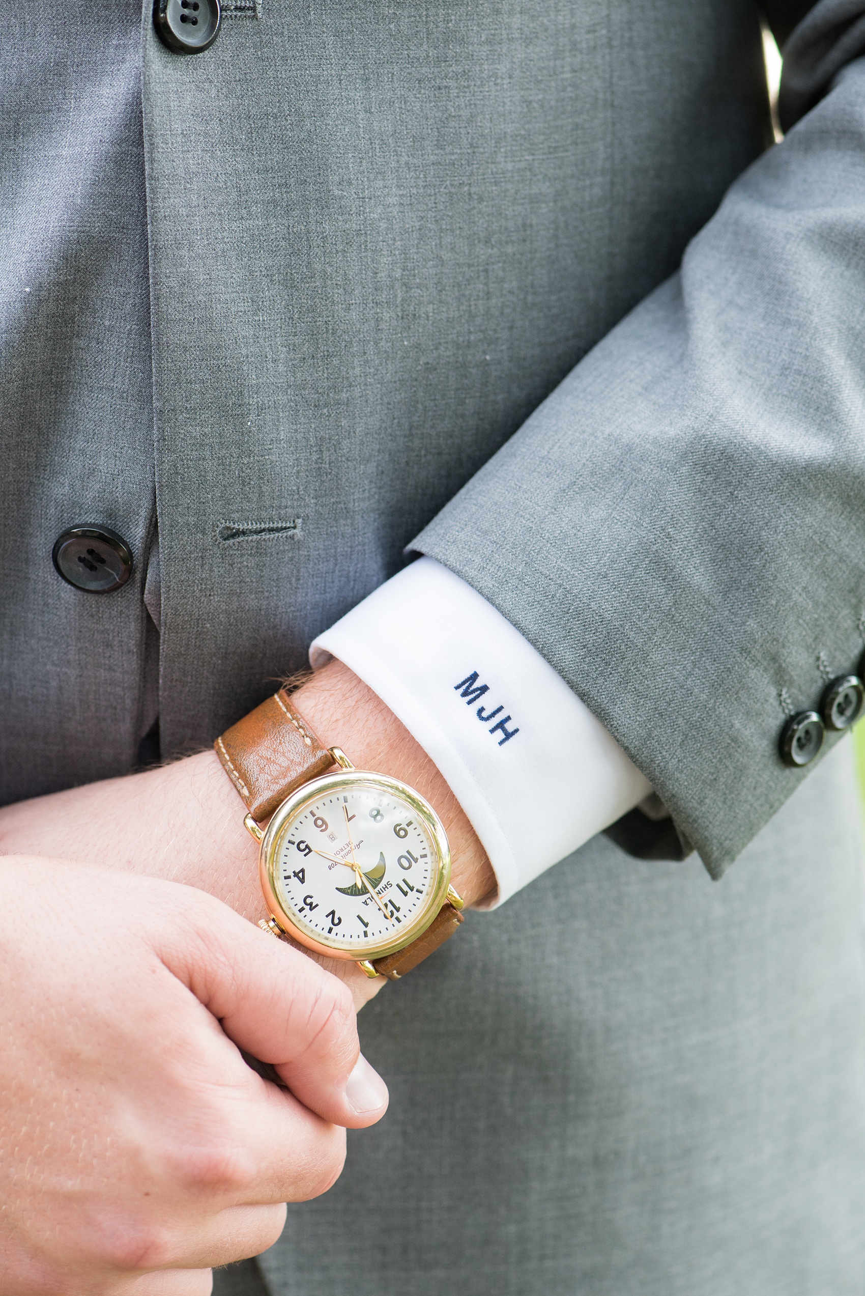 Pictures by Mikkel Paige Photography of a wedding in Durham, North Carolina. The groom wore a special watch for the day and a monogrammed cuffs button down shirt and grey suit. Their beautiful golf course photo ideas with the bridal party, and bride will provide endless inspiration! Click through to our website for the complete post and details. #durhamNC #northcarolinawedding #southernwedding #golfcoursewedding #CountryClubWedding #bluebridesmaids #DurhamWedding #summerwedding