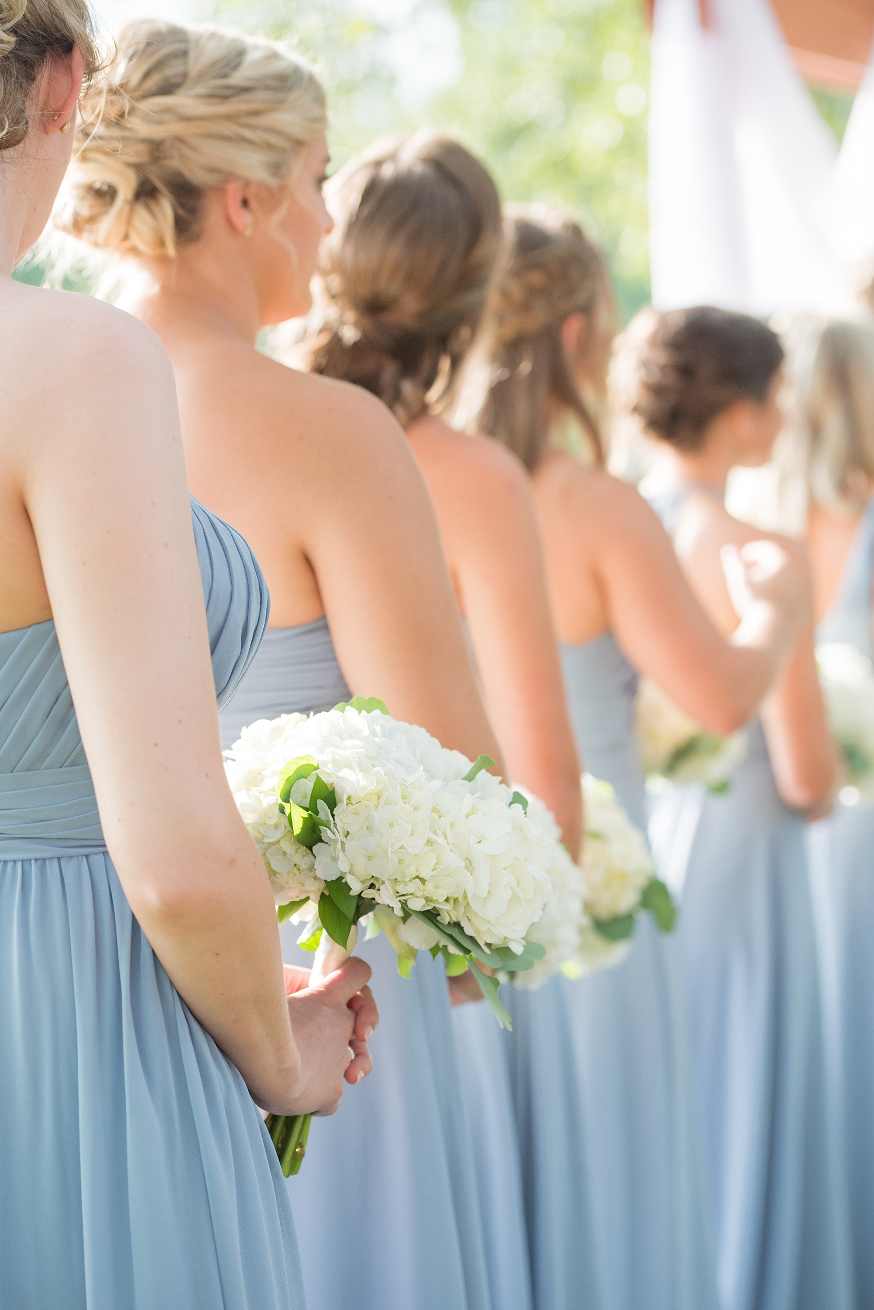 Pictures by Durham wedding photographer, Mikkel Paige Photography, in North Carolina. The beautiful white hydrangea flowers from the days events, pretty garden-like golf course at Croasdaile Country Club and various photo ideas with the bridesmaids in blue and bride in a low-back gown will inspire you! Click through to our website for the complete post and details. #durhamNC #northcarolinawedding #southernwedding #golfcoursewedding #CountryClubWedding #bluebridesmaids #DurhamWedding #summerwedding