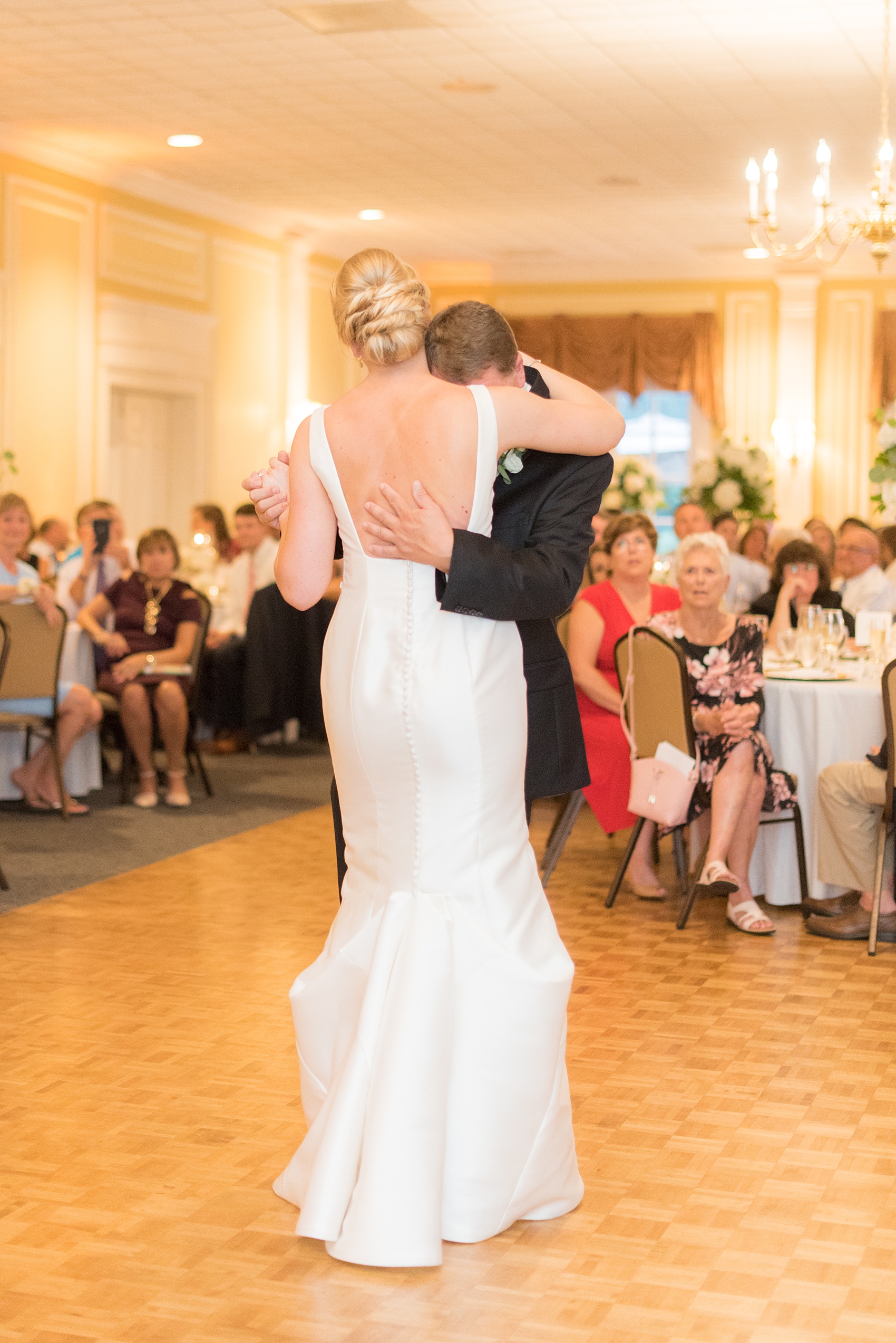 Pictures by Mikkel Paige Photography of a wedding in Durham, North Carolina. The beautiful hydrangea flowers from the day’s events adorned the party room that overlooked a pretty garden-like golf course. The father-of-the-bride shared a special dance with his daughter before a reception glowstick exit. Click through to our website for the complete post! #durhamNC #northcarolinawedding #golfcoursewedding #CountryClub #DurhamWedding #summerwedding #weddingexit #glowsticks #fatherdaughterdance