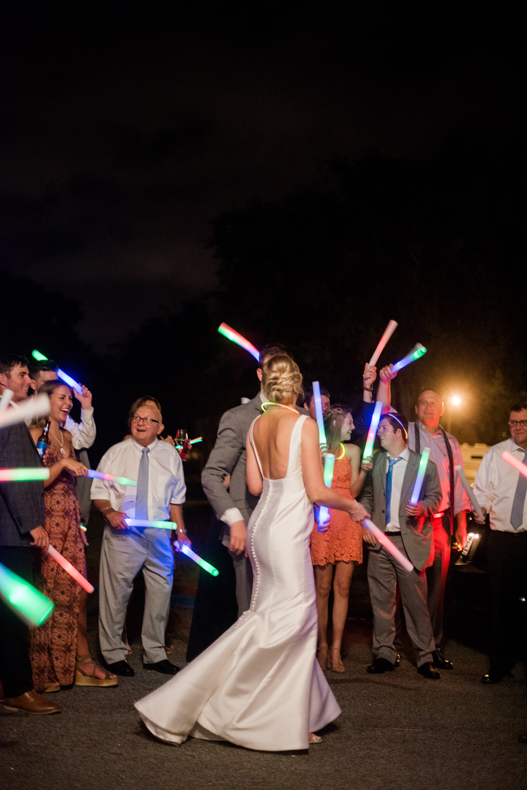 Pictures by Mikkel Paige Photography of a wedding in Durham, North Carolina. The beautiful white hydrangea flowers from the day’s events adorned a reception with cocktail hour overlooking a pretty garden-like golf course. The DJ played tunes everyone danced the night away to before a glowstick exit. Click through to our website for the complete post and details! #durhamNC #northcarolinawedding #golfcoursewedding #CountryClubWedding #DurhamWedding #summerwedding #weddingexit #glowstickexit