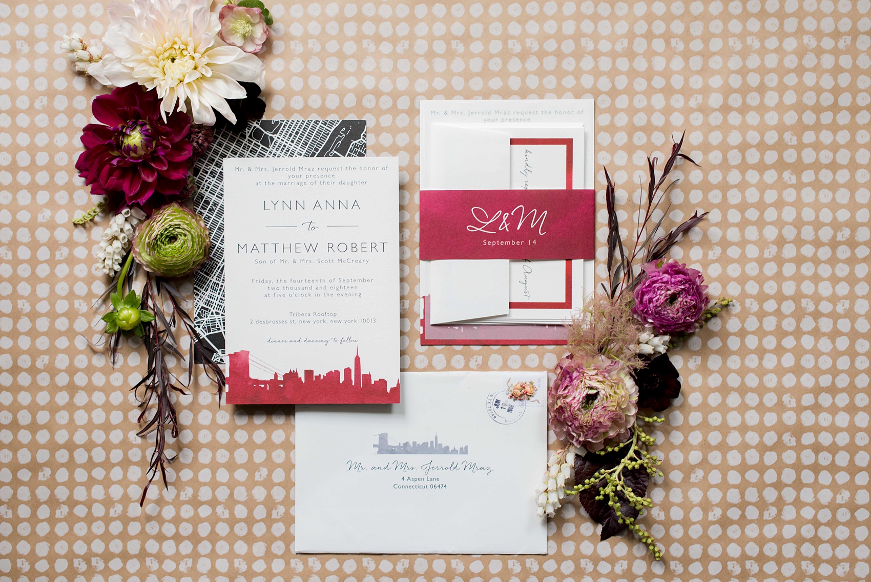 Wedding photos at Tribeca Rooftop by Mikkel Paige Photography, in NYC. This Manhattan venue has the perfect view of the New York City skyline including Freedom Tower. This lay flat photo of their invitation shows their fall flowers and red skyline silhouette. #ManhattanWedding #TribecaRooftop #TribecaRooftopWeddingPhotos #SeptemberWedding #weddinginvitation #manhattanweddinginvitation #MikkelPaige #WeddingPhotos #CranberryWedding #RedWeddingInspiration #BerryWeddingInspiration