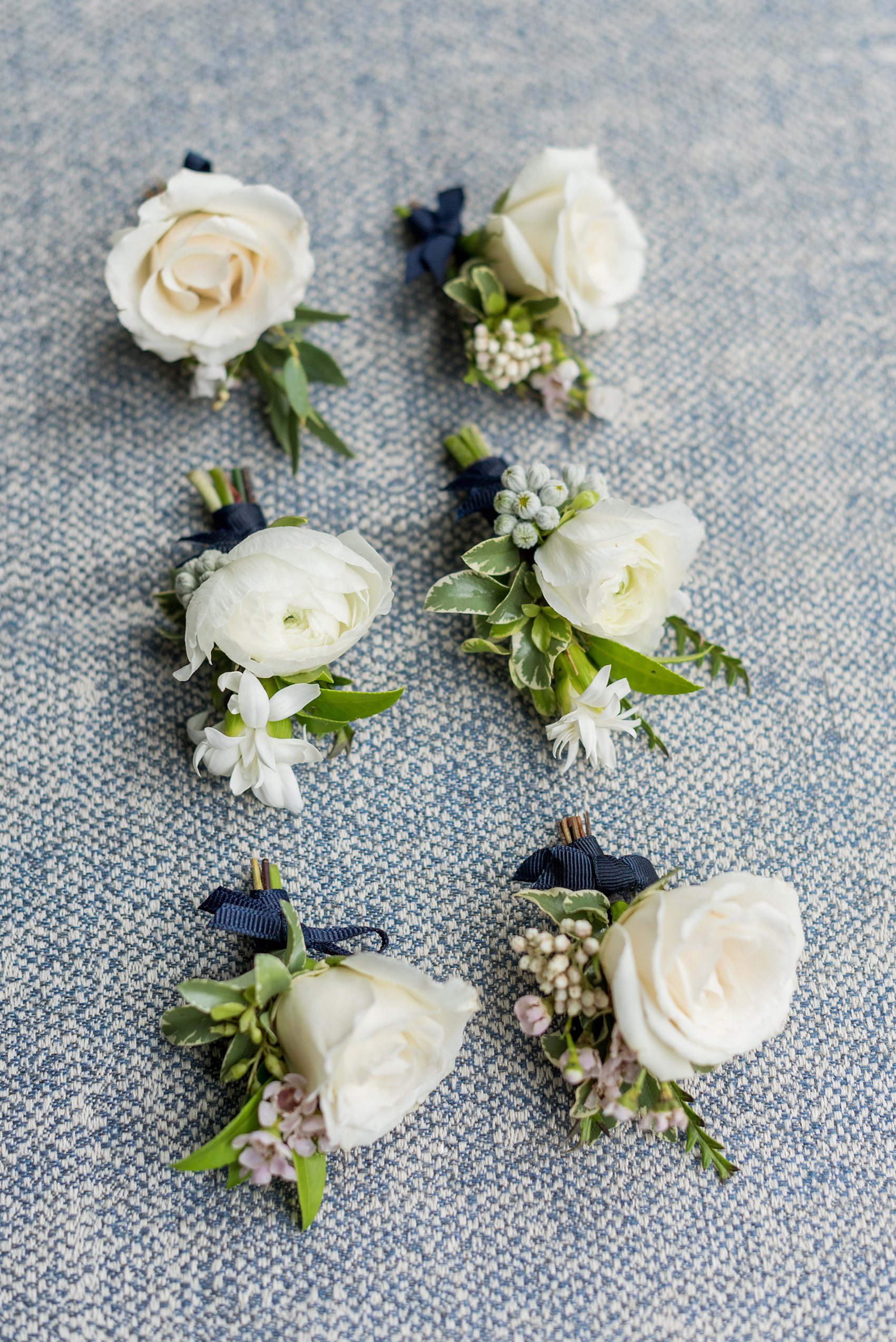 Prospect Park Boathouse wedding photos in Brooklyn, New York by Mikkel Paige Photography. Photos include gay wedding decor inspiration and details like white ranunculus boutonnieres with navy blue ribbon. This city ceremony was performed at City Hall in Manhattan and the Brooklyn venue joined indoors with outdoors in a park setting with a historic New York City building. #mikkelpaige #prospectparkboathouse #brooklynwedding #brooklynweddingphotographer #gayweddingideas