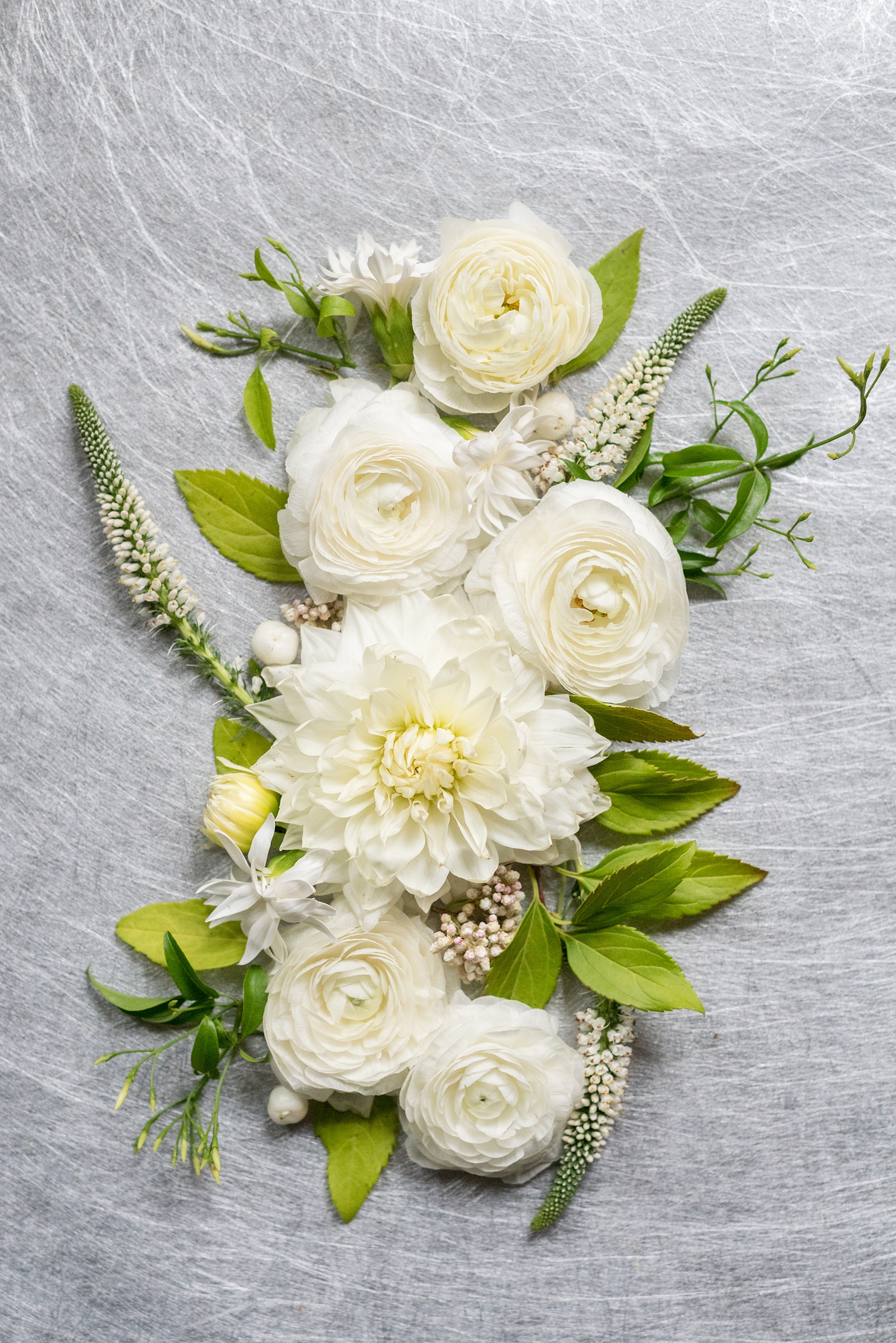 Prospect Park Boathouse wedding photos in Brooklyn, New York by Mikkel Paige Photography. This city wedding venue joins the indoors with the outdoors in a park setting with a historic New York City building. Photos include gay wedding decor inspiration and details with white flowers including dahlias, ranunculus, Veronica and Jasmine for a green and white palette. #mikkelpaige #prospectparkboathouse #brooklynwedding #brooklynweddingphotographer #whiteflowers #greenandwhitewedding #greenwedding