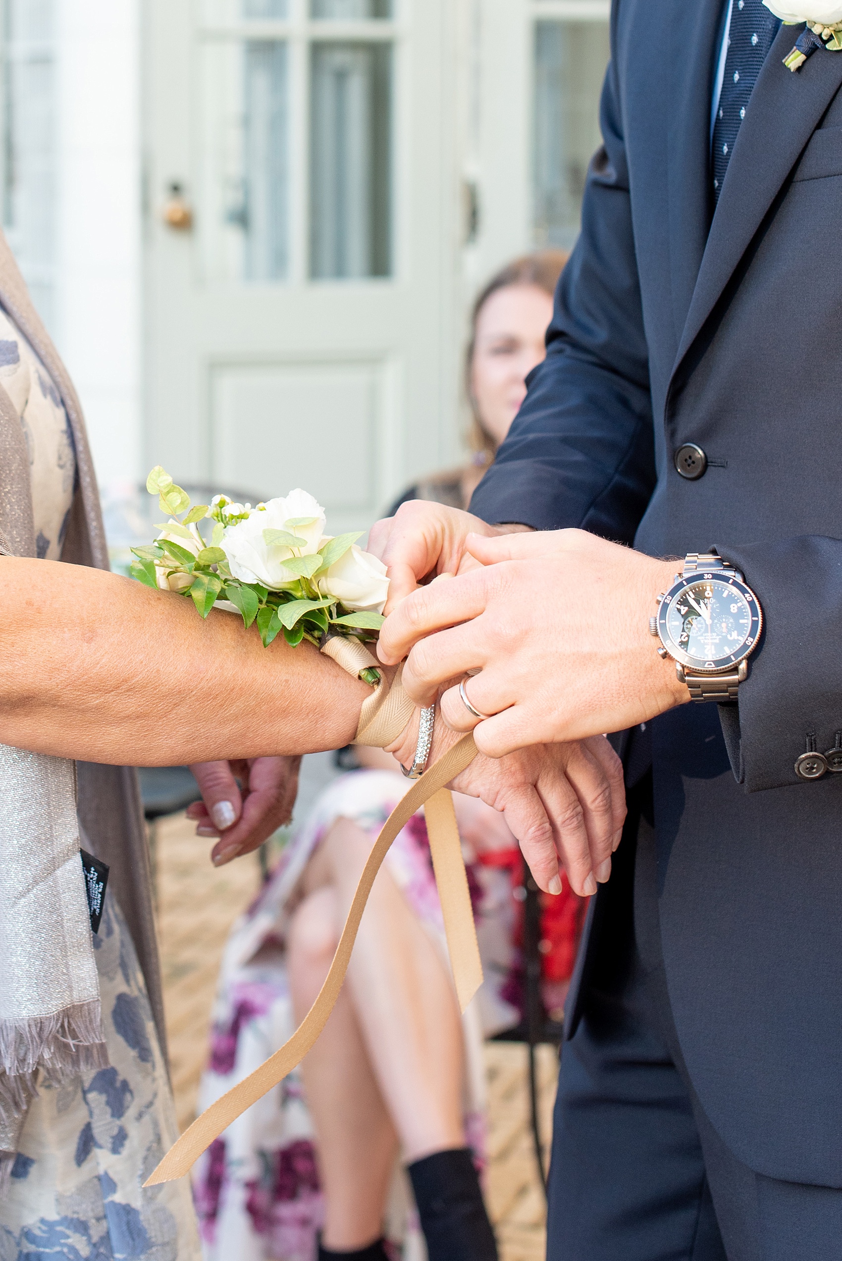 Prospect Park Boathouse wedding photos in Brooklyn, New York by Mikkel Paige Photography. This city wedding venue joins the indoors with the outdoors in a park setting with a historic New York City building. Photos include gay wedding decor inspiration and details with white flower corsages for their moms, including spray roses to go with their green and white colors. #mikkelpaige #prospectparkboathouse #brooklynwedding #brooklynweddingphotographer #whitecorsages #greenandwhitewedding