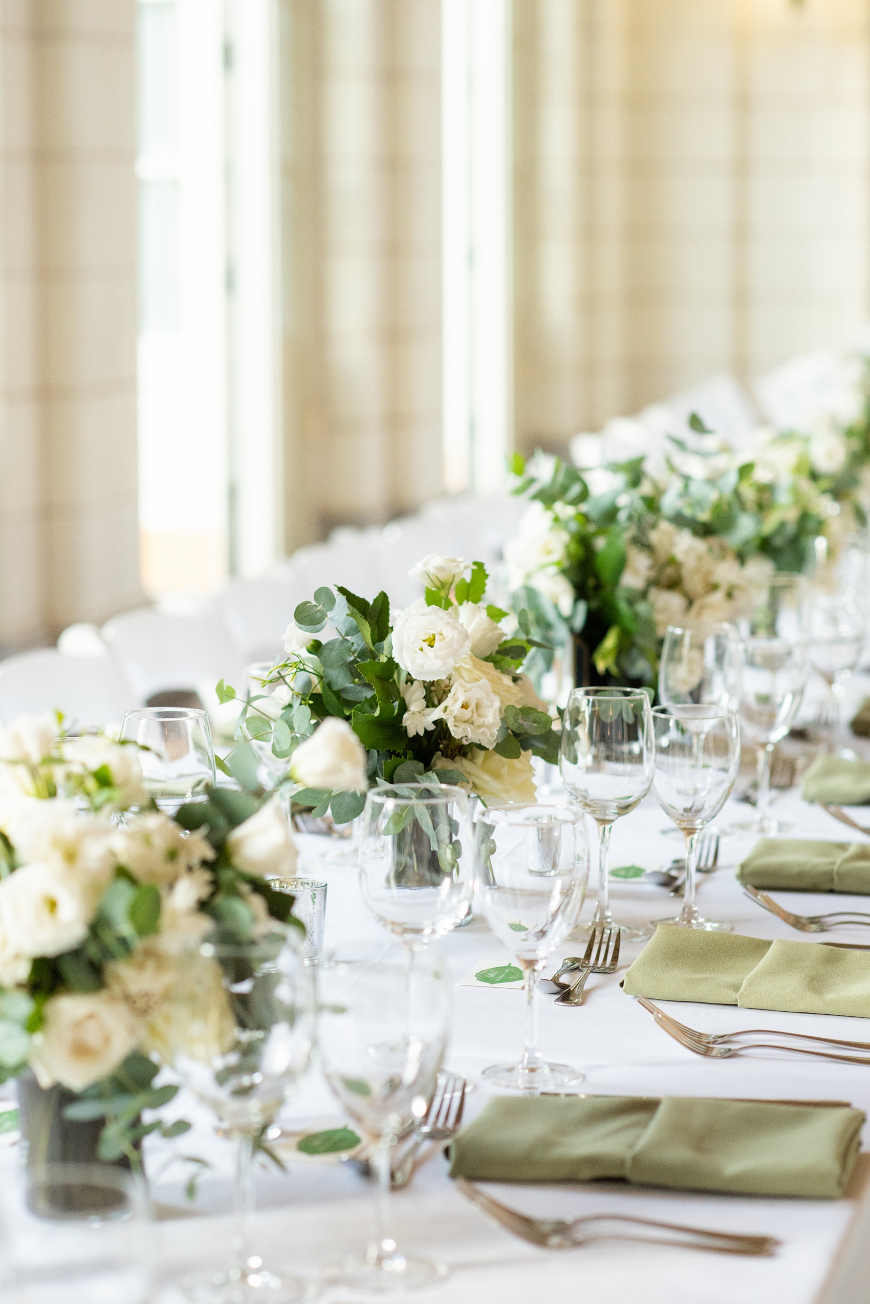 Prospect Park Boathouse wedding photos in Brooklyn, New York by Mikkel Paige Photography. This city wedding venue joins the indoors with the outdoors in a park setting with a historic New York City building. Photos include gay wedding decor inspiration and details with white flowers including dahlias, ranunculus, Veronica and Jasmine for a green and white palette. #mikkelpaige #prospectparkboathouse #brooklynwedding #brooklynweddingphotographer #whiteflowers #greenandwhitewedding #greenwedding